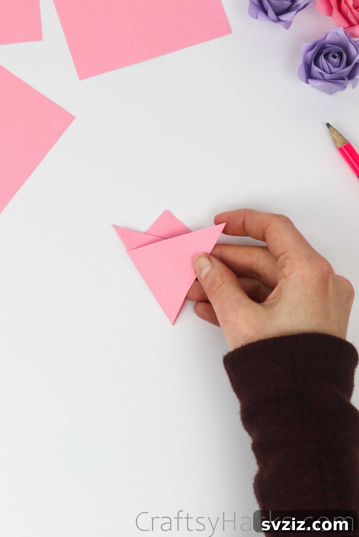 Your Simple Guide to Gorgeous Paper Roses 11 Both bottom corners of the folded paper are now symmetrically folded up towards the marked points