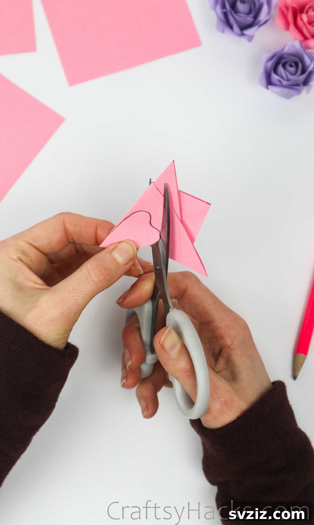 Your Simple Guide to Gorgeous Paper Roses 14 Scissors precisely cutting along the drawn petal line on the folded paper