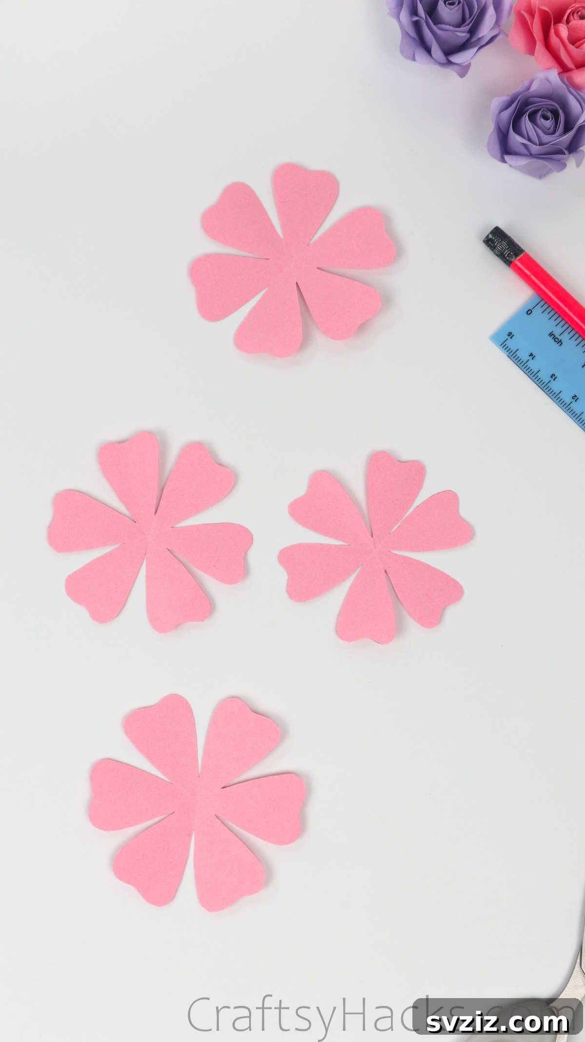 Your Simple Guide to Gorgeous Paper Roses 17 Four identical pink six-petal paper flower cut-outs, ready for the next stage
