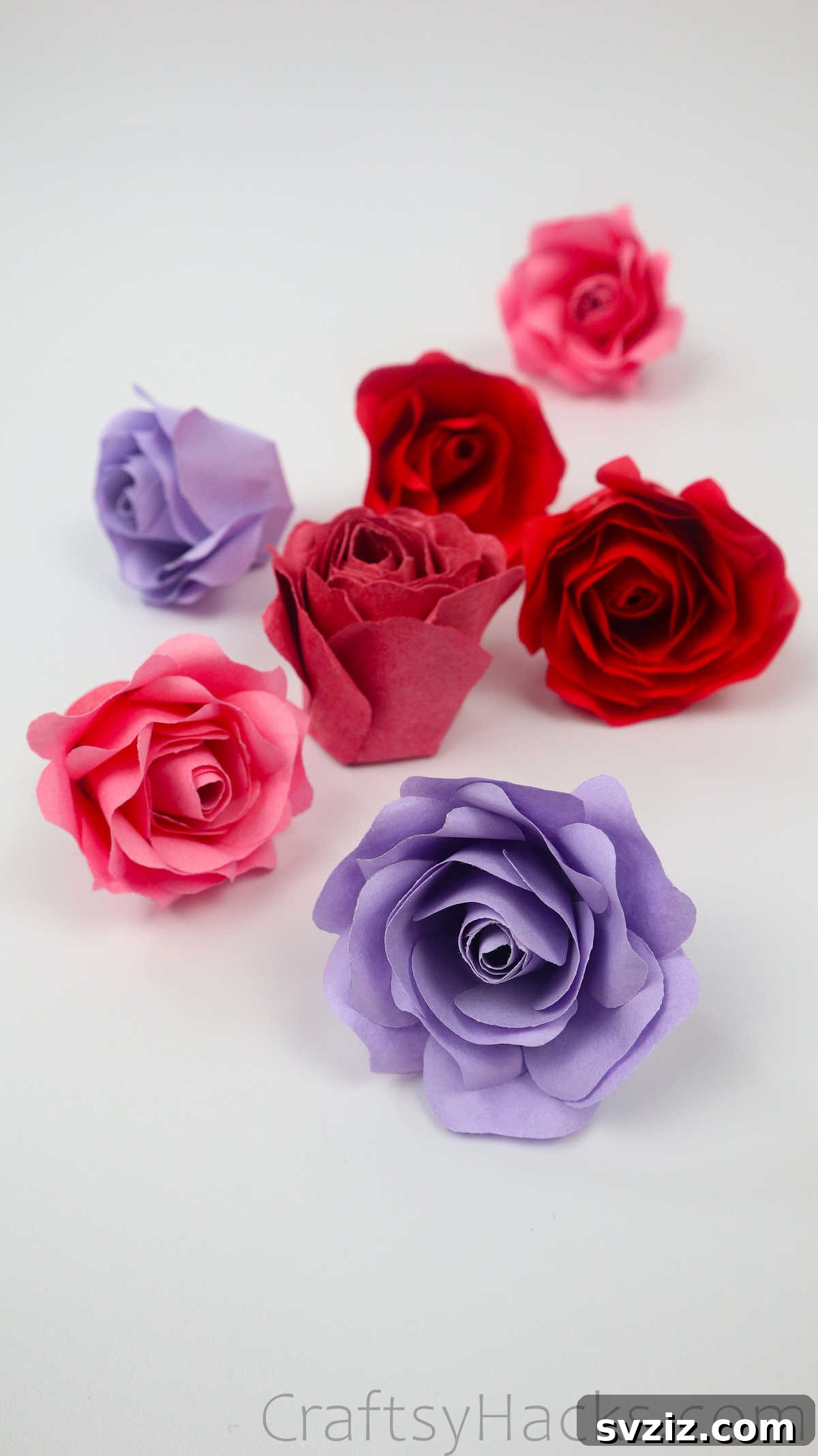 Your Simple Guide to Gorgeous Paper Roses 3 A charming pile of various pink and red paper roses, ready for crafting