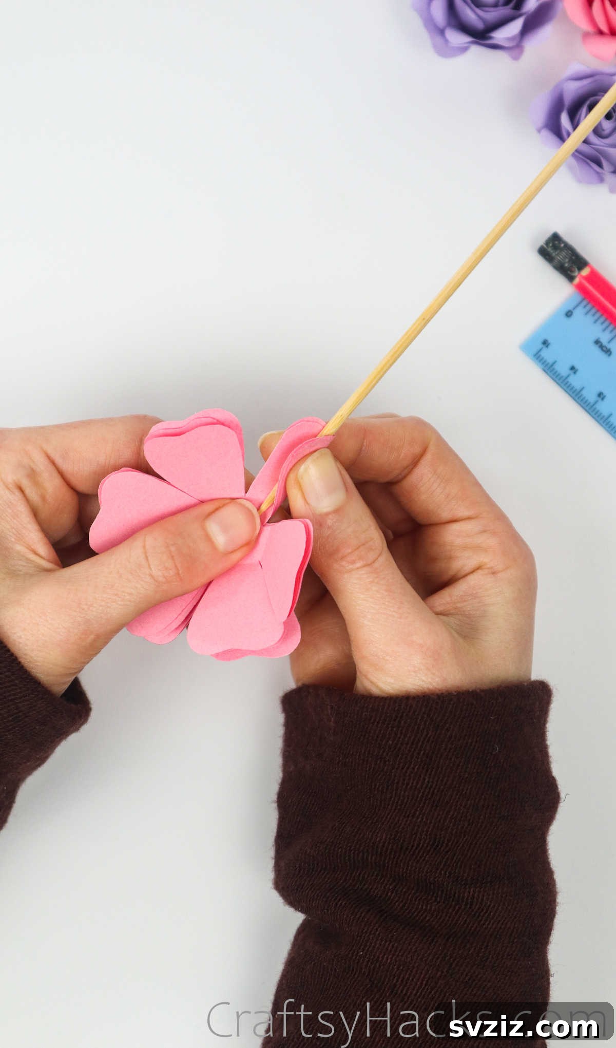 Your Simple Guide to Gorgeous Paper Roses 21 A wooden skewer is used to gently curve a paper petal, adding natural dimension