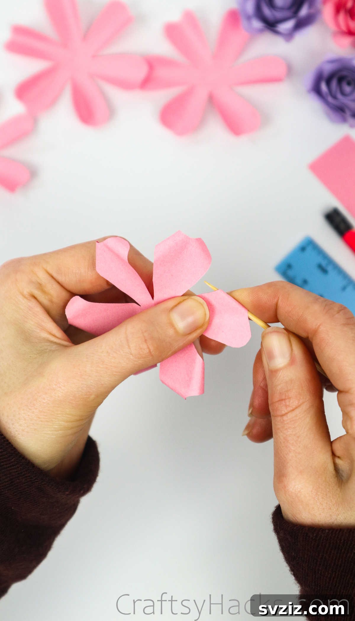 Your Simple Guide to Gorgeous Paper Roses 24 A toothpick is used to delicately curl the tip of a paper petal, adding definition