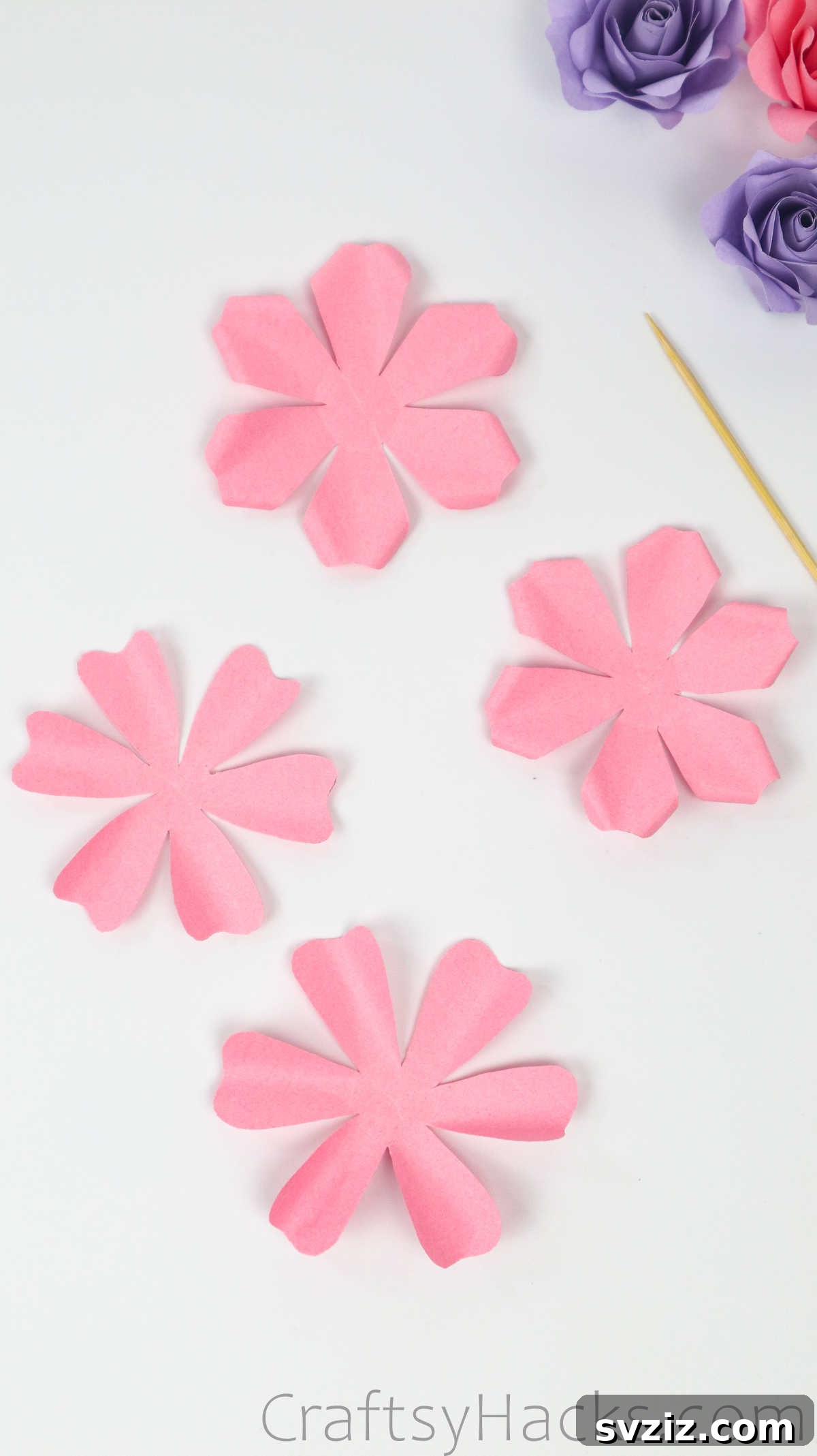 Your Simple Guide to Gorgeous Paper Roses 26 Two paper flower pieces with carefully curled petal tips, designated as outer layers