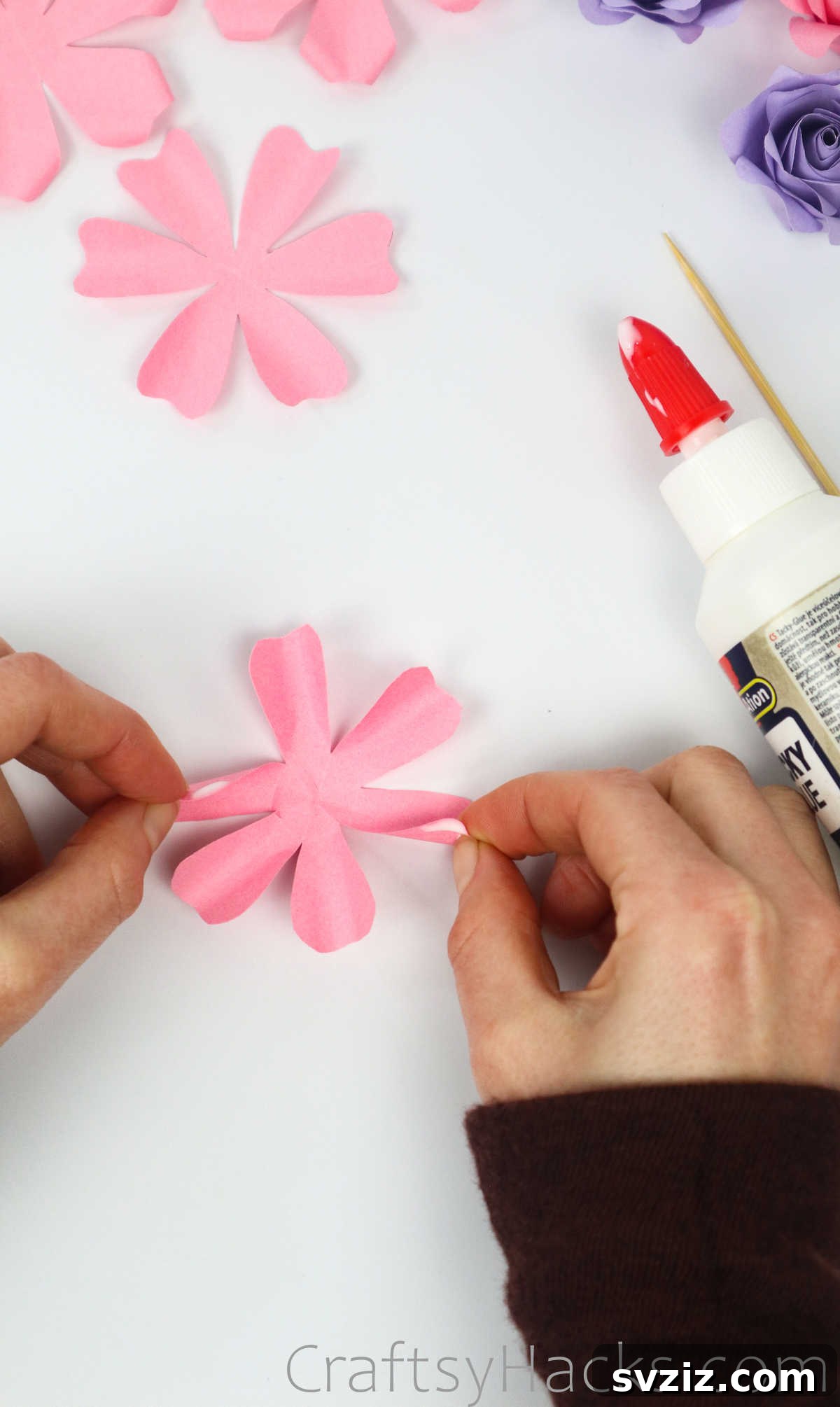 Your Simple Guide to Gorgeous Paper Roses 28 A tiny dab of glue applied to the tip of a paper petal, ready for forming the rose bud