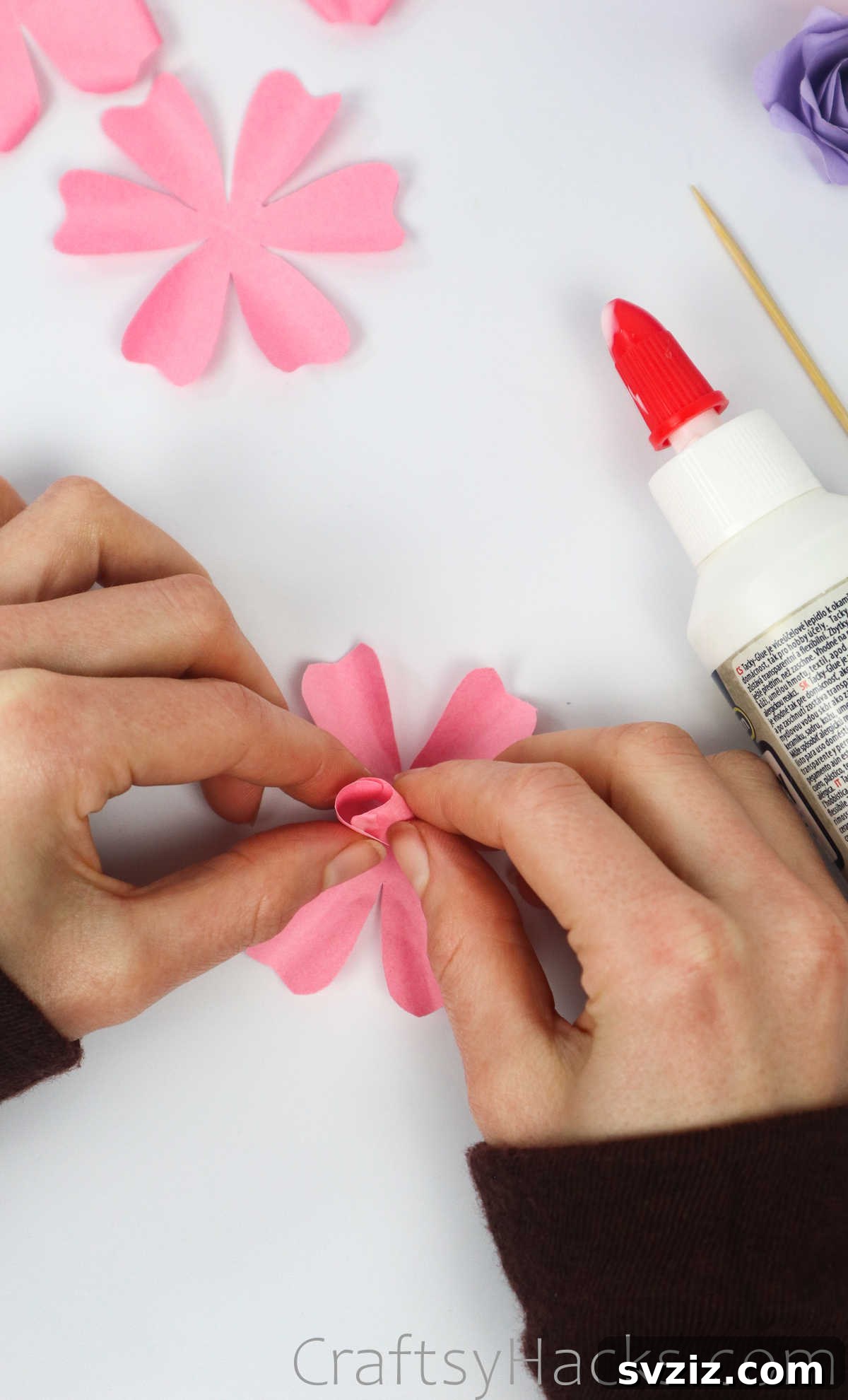Your Simple Guide to Gorgeous Paper Roses 30 Two opposite paper petals glued together at their tips, starting to form the rose's central bud