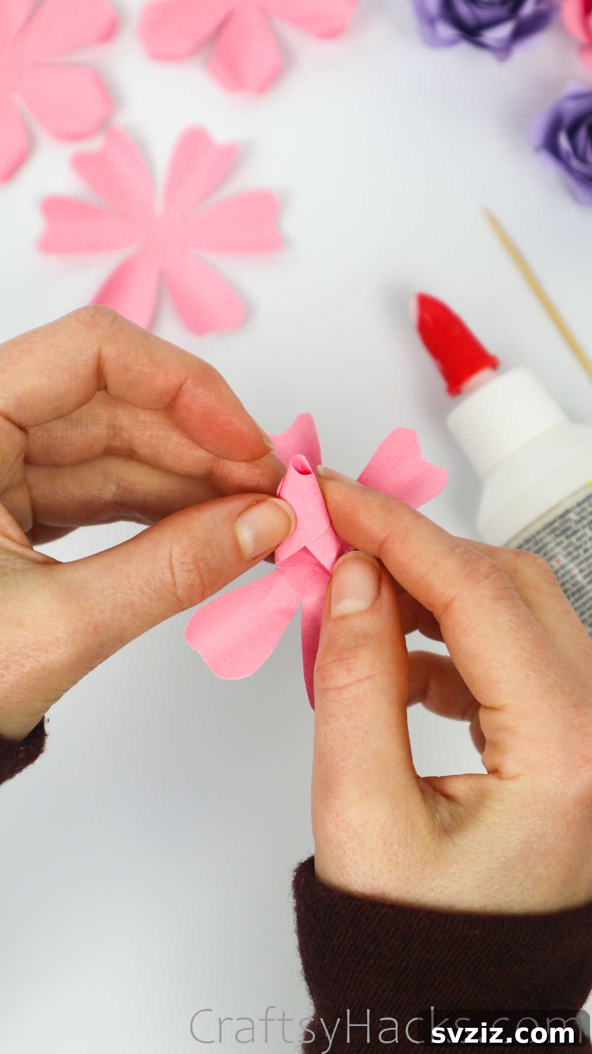 Your Simple Guide to Gorgeous Paper Roses 31 A closer view of the first two petals securely glued, forming the initial tight center of the paper rose bud