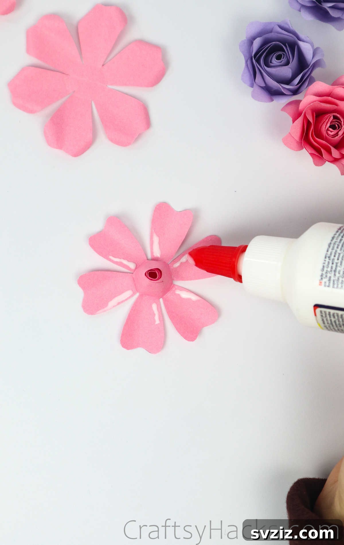 Your Simple Guide to Gorgeous Paper Roses 39 Thin lines of glue are applied to each petal of the second paper flower layer