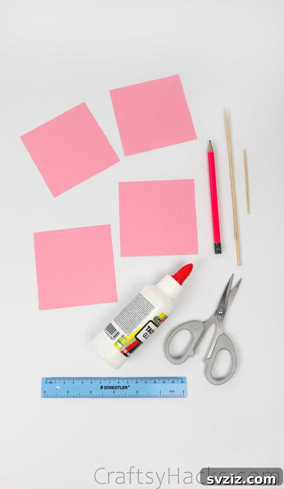 Your Simple Guide to Gorgeous Paper Roses 5 A flat lay showing all the simple tools and materials needed to make DIY paper roses: paper, pencil, scissors, glue, toothpick, wooden skewer, and ruler.