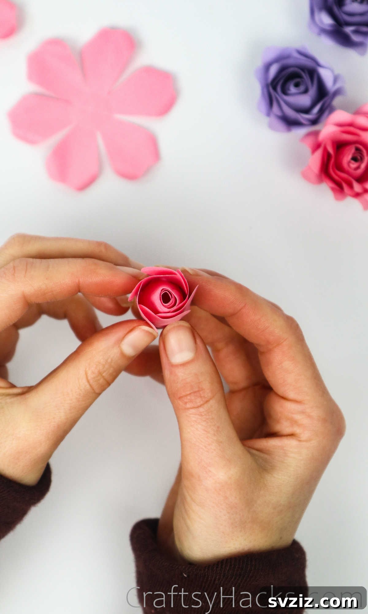 Your Simple Guide to Gorgeous Paper Roses 41 Petals of the second layer are gently pulled and glued around the rose bud, creating an unfurling effect