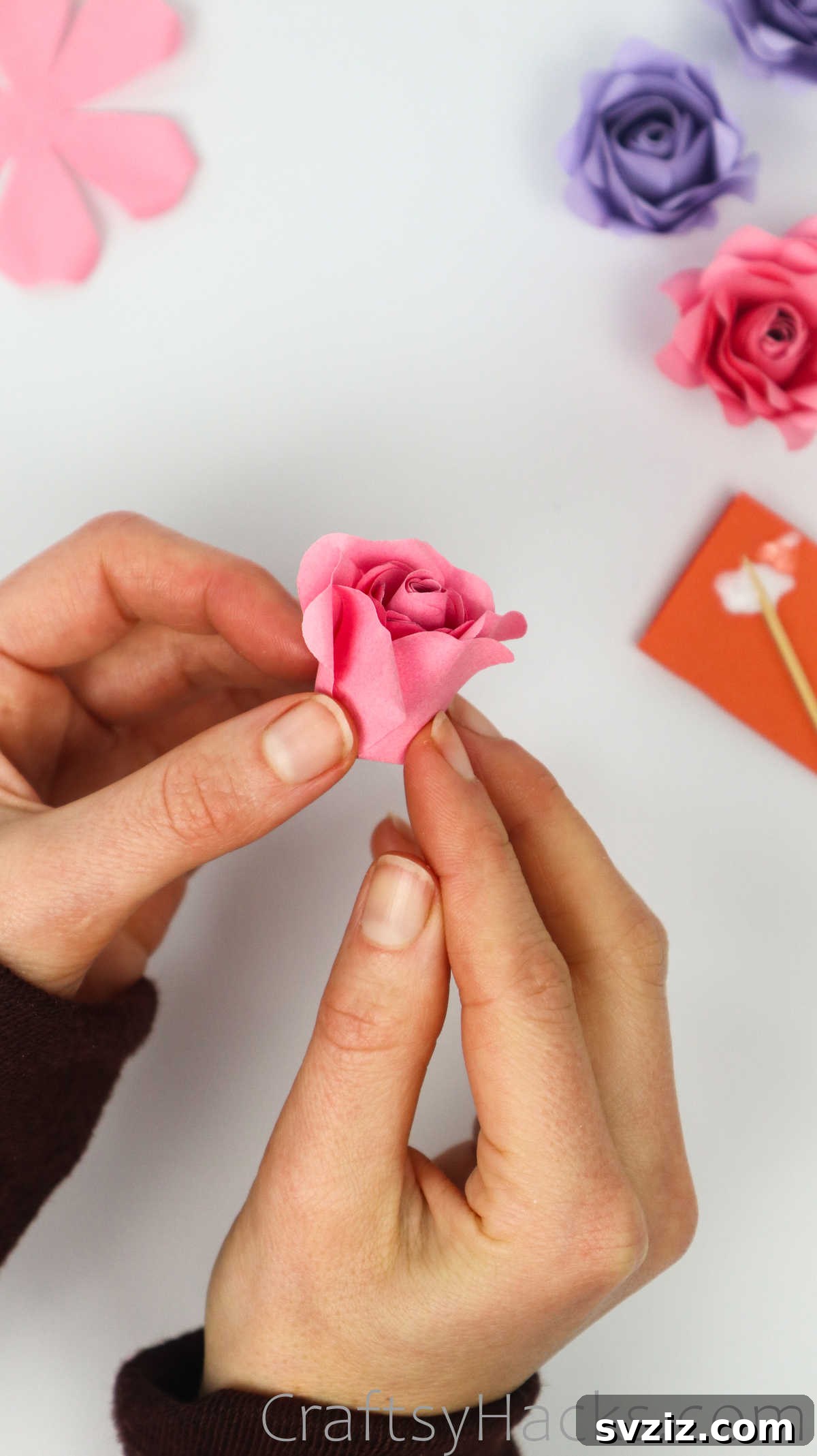 Your Simple Guide to Gorgeous Paper Roses 46 The rose's petals being carefully glued to create a full, layered appearance