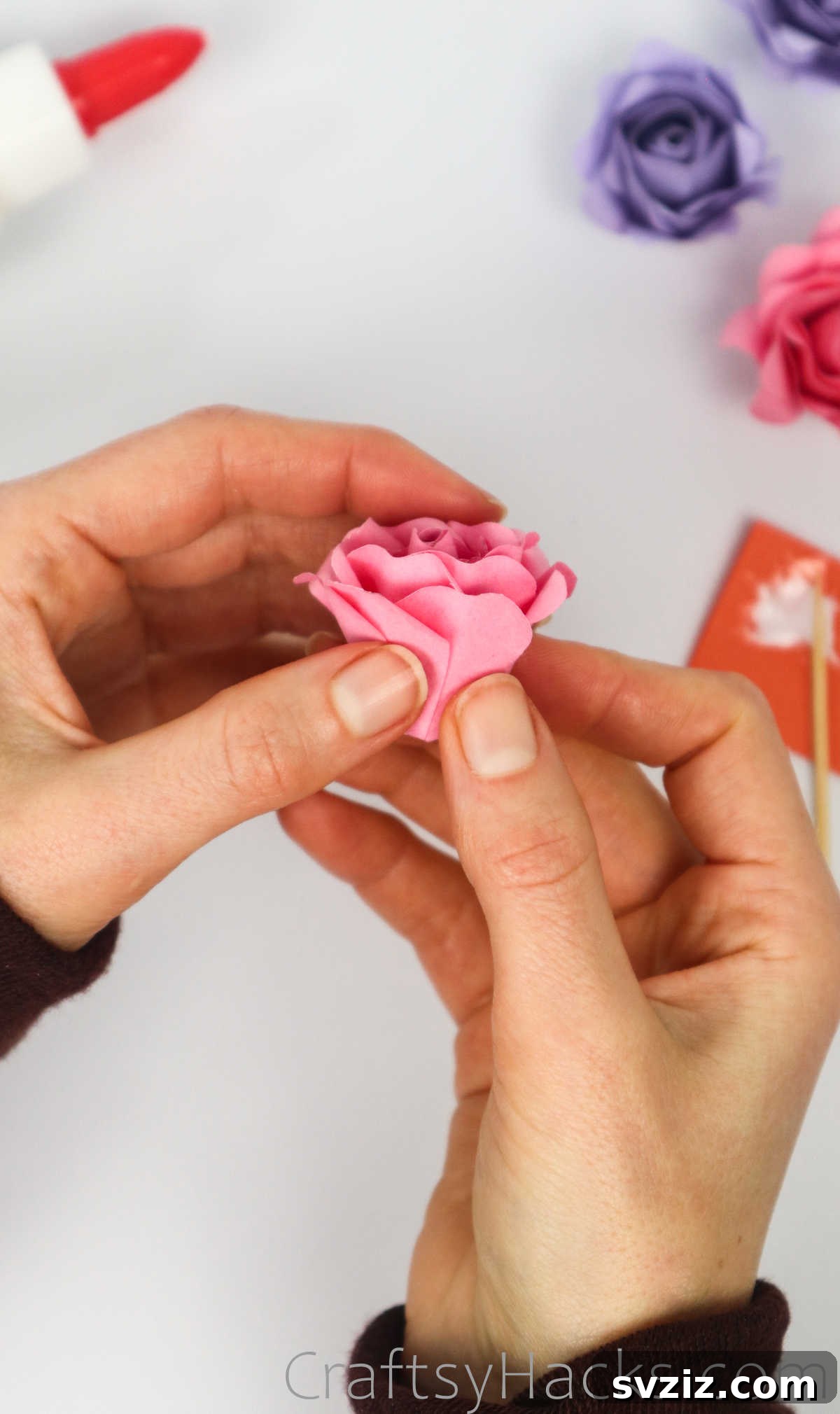 Your Simple Guide to Gorgeous Paper Roses 48 Carefully gluing the final petals of the outermost layer to complete the paper rose