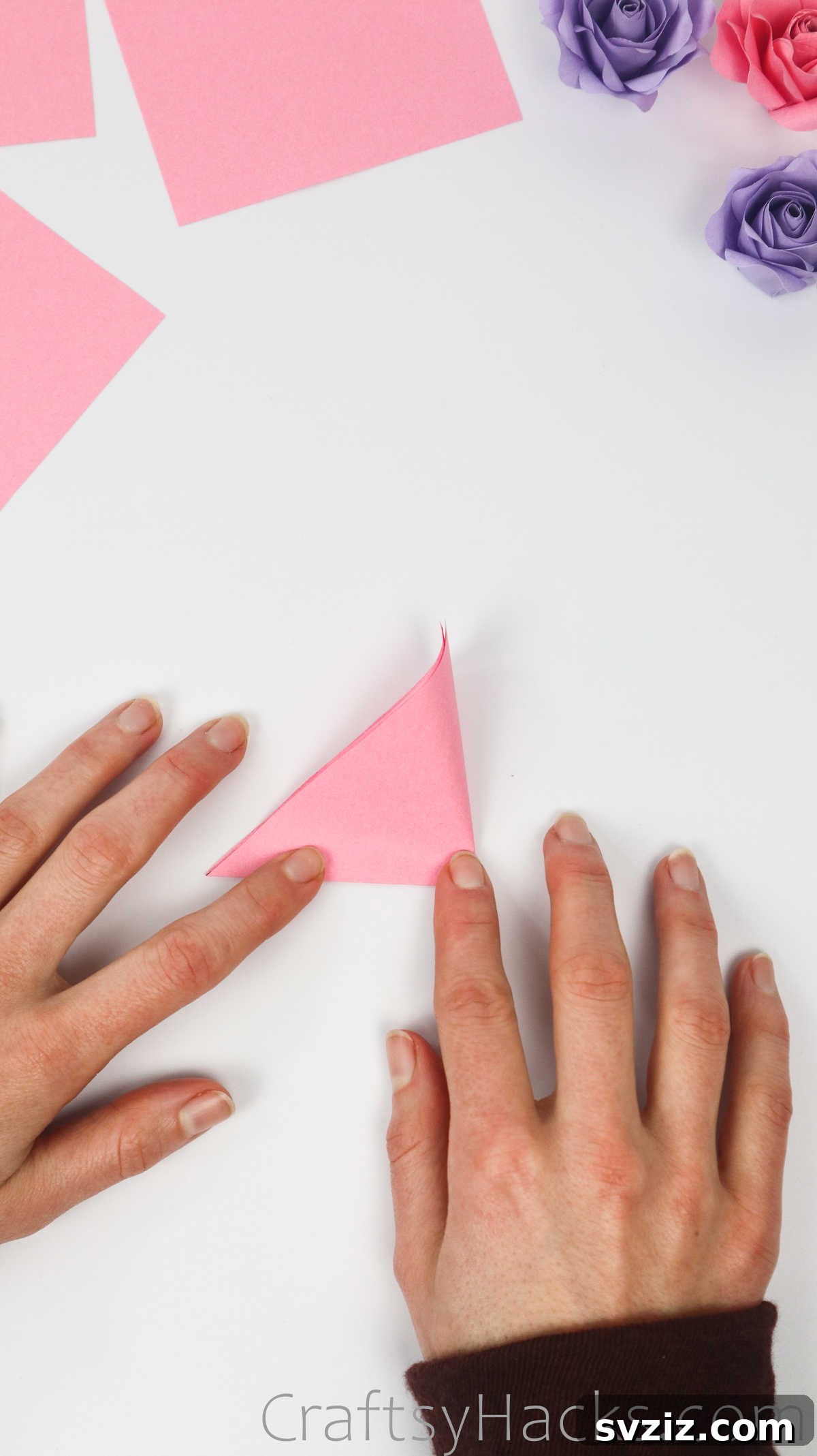 Your Simple Guide to Gorgeous Paper Roses 8 The folded paper triangle is creased in half to form an even smaller triangle