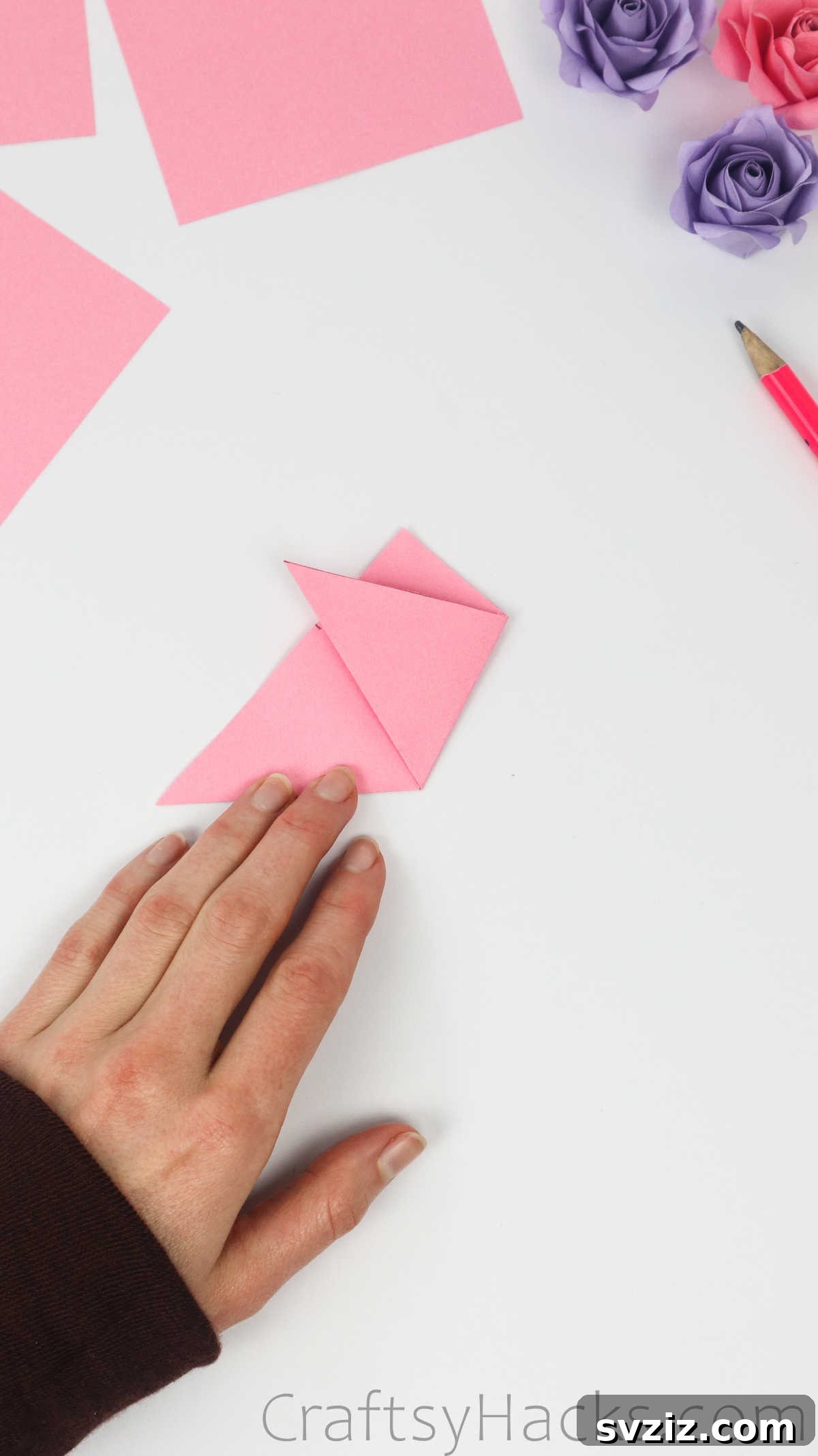 Your Simple Guide to Gorgeous Paper Roses 10 The bottom corner of the paper is folded up towards the 1.5-inch pencil mark