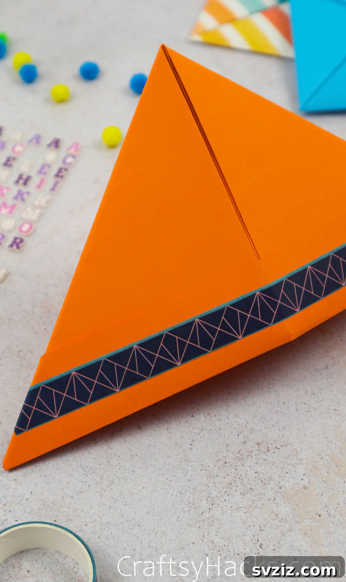 A beautifully decorated paper hat with various embellishments, showcasing a complete and vibrant craft.