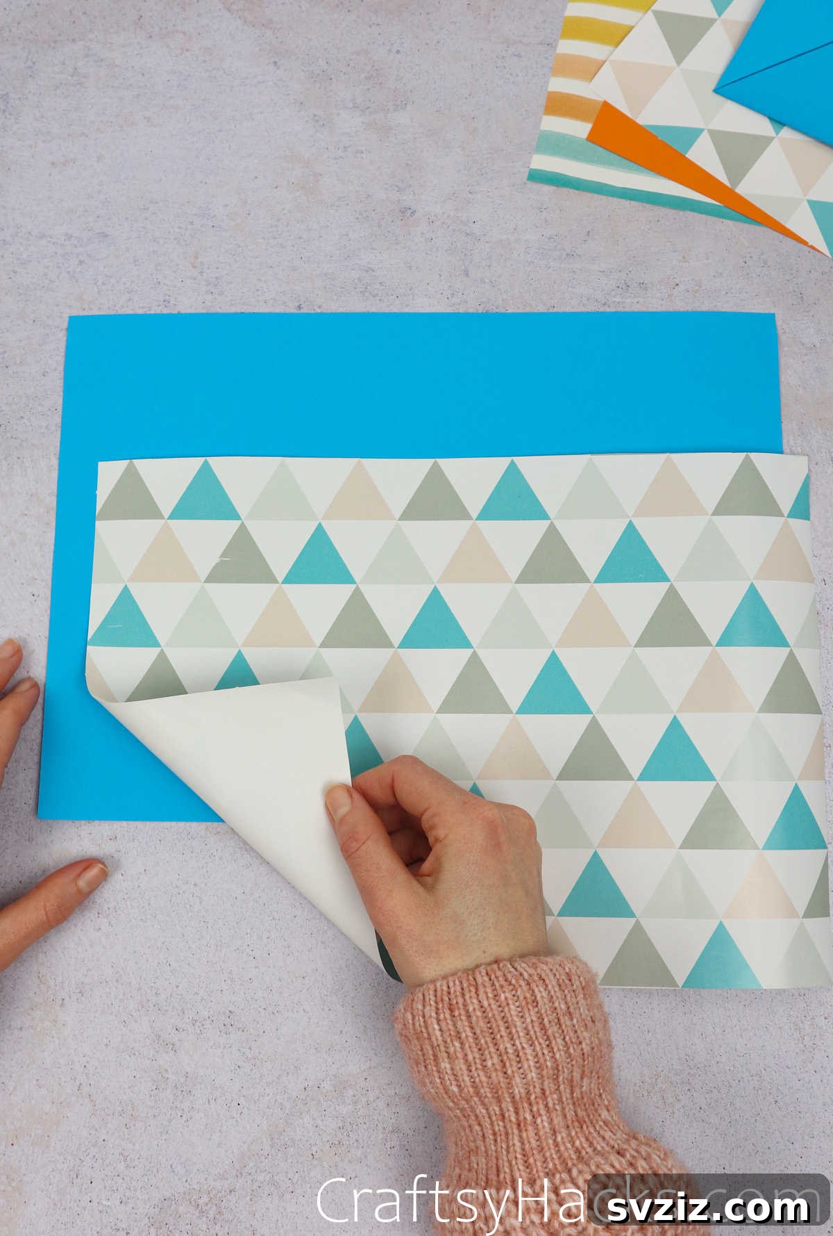 A blank rectangular sheet of craft paper laid flat on a surface, ready for folding.