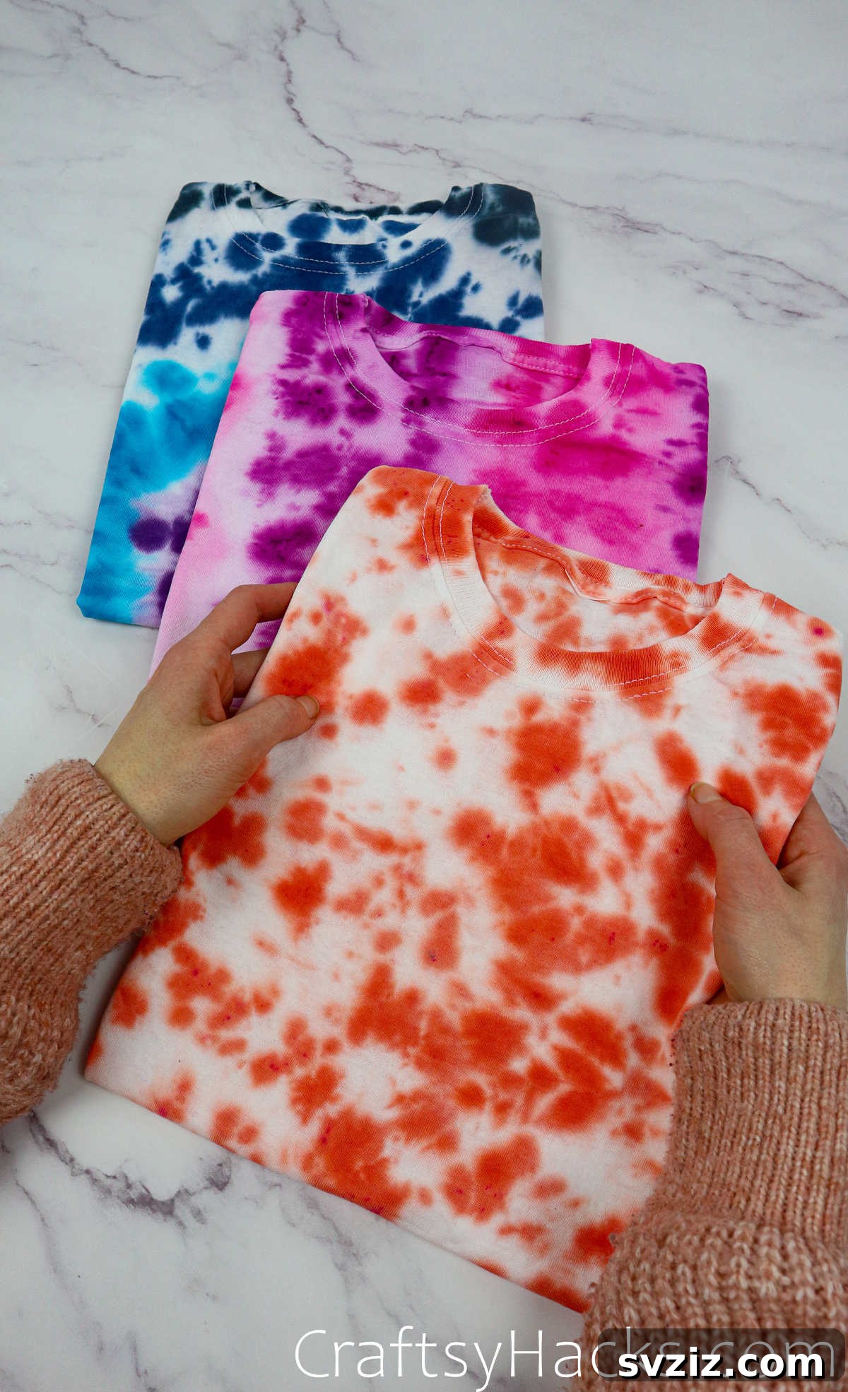 holding tie dye shirt