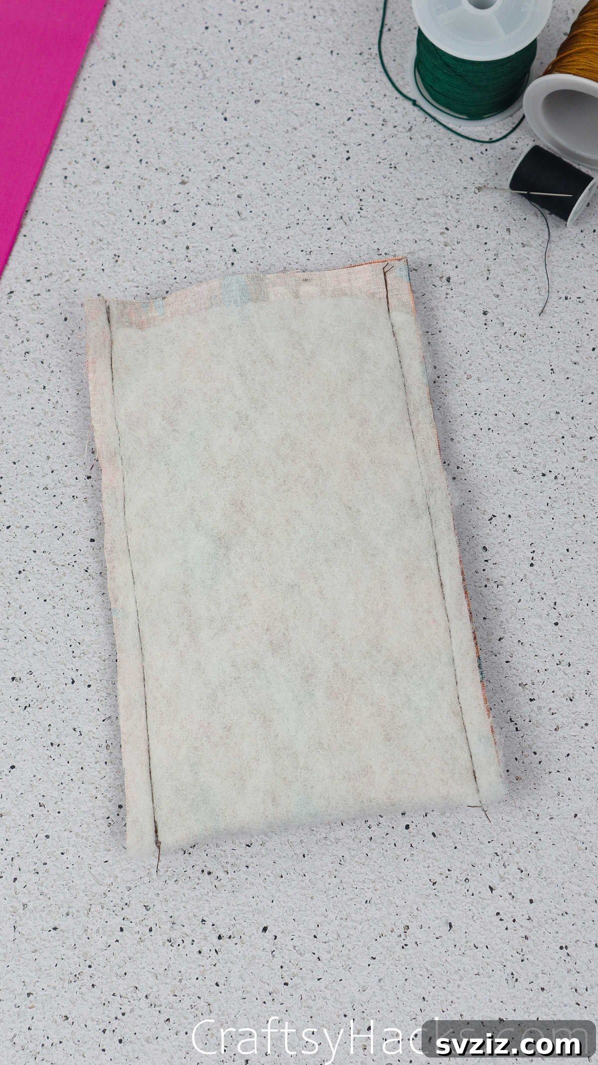 The sewn wadding and fabric, demonstrating the completed side seams before turning the pouch right side out.