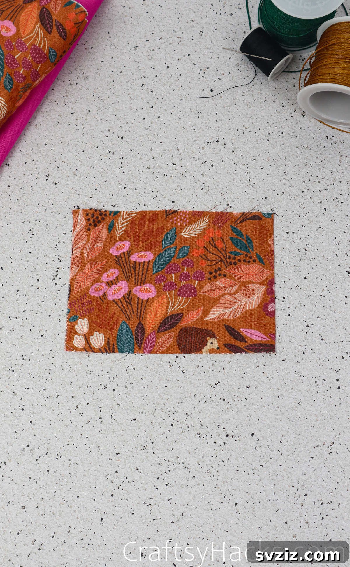 A small rectangular fabric piece for the inner pocket, laid flat and ready for folding and ironing the edges.