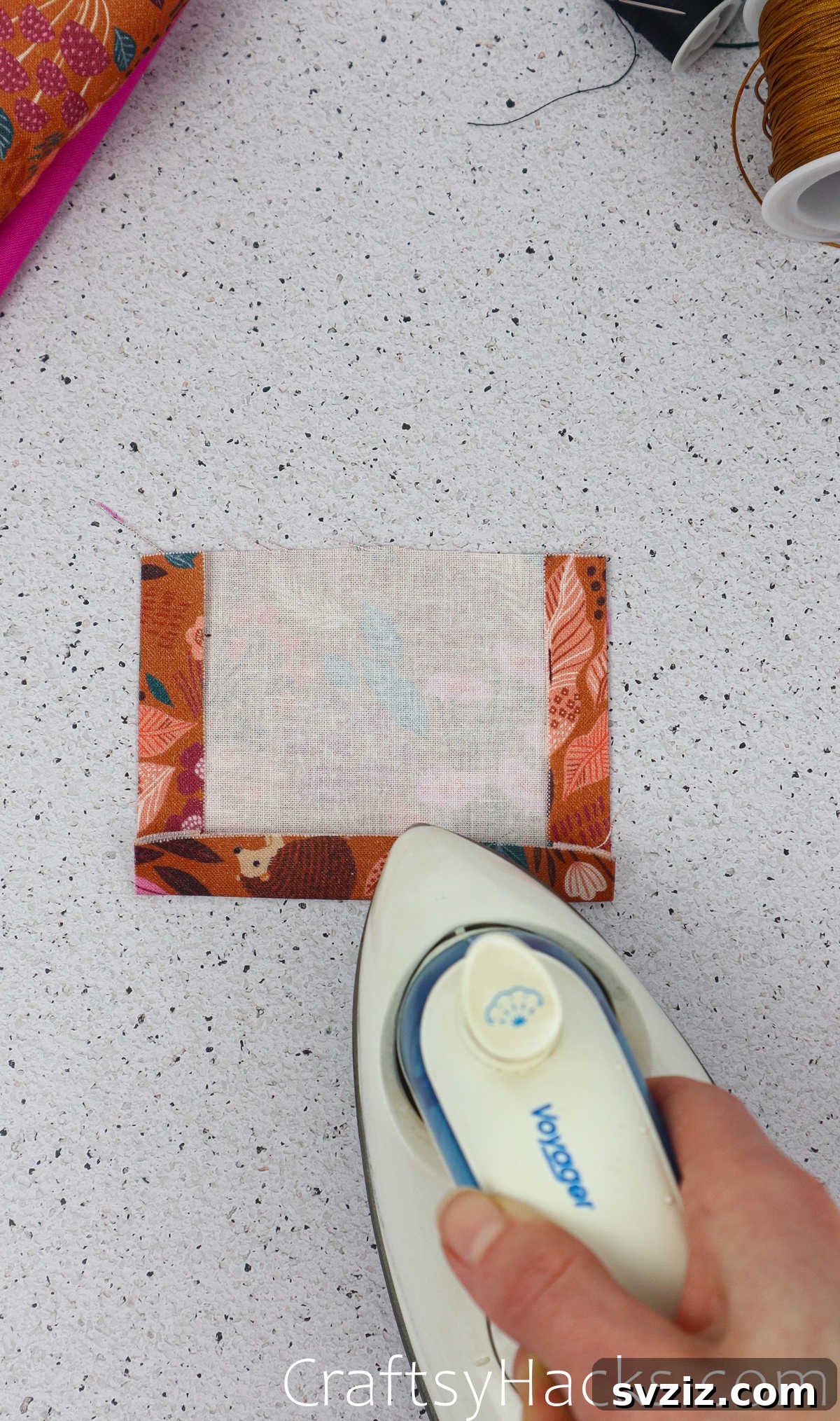 The pocket fabric being ironed after folding all three sides (left, right, bottom) for a neat appearance.
