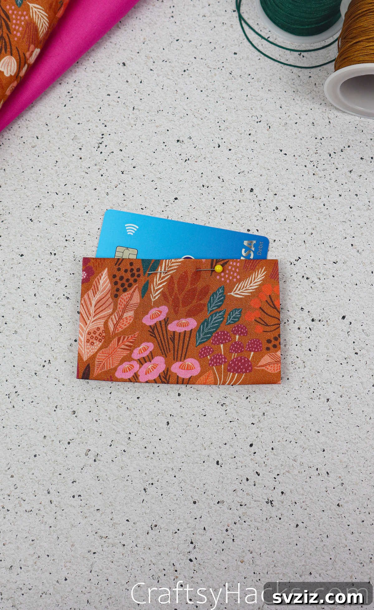 A credit card inserted into the folded pocket fabric, demonstrating its intended use and confirming the size.