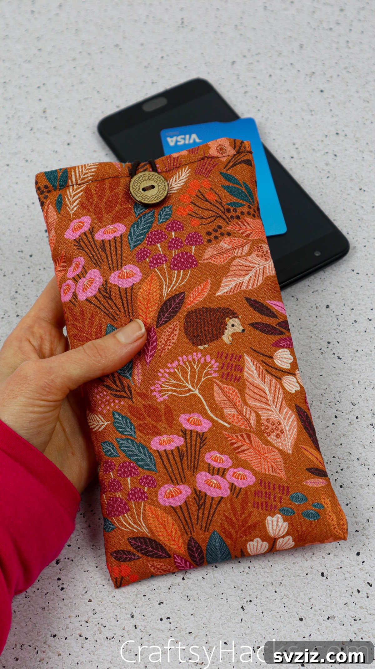 A close-up of a handcrafted fabric phone case, showcasing its soft texture and unique pattern, ready to protect your device.