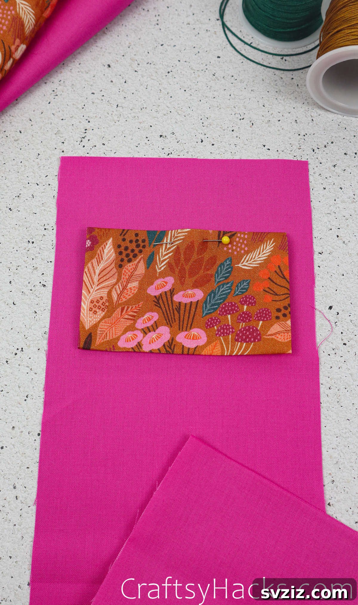 The prepared fabric pocket being pinned onto the lining fabric, ensuring even placement and leaving the top open.