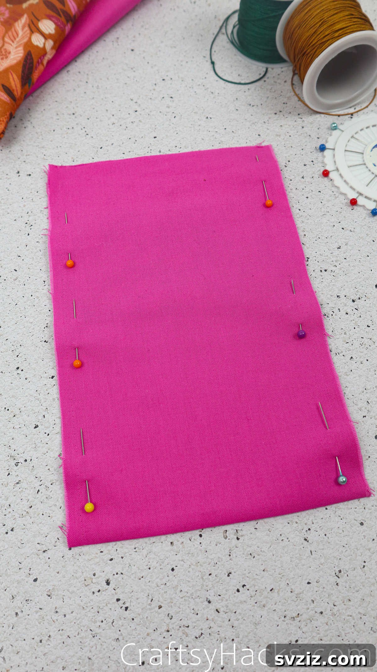 Close-up view of the pinned lining fabric edges, showing the precise placement of pins for a quarter-inch seam allowance.