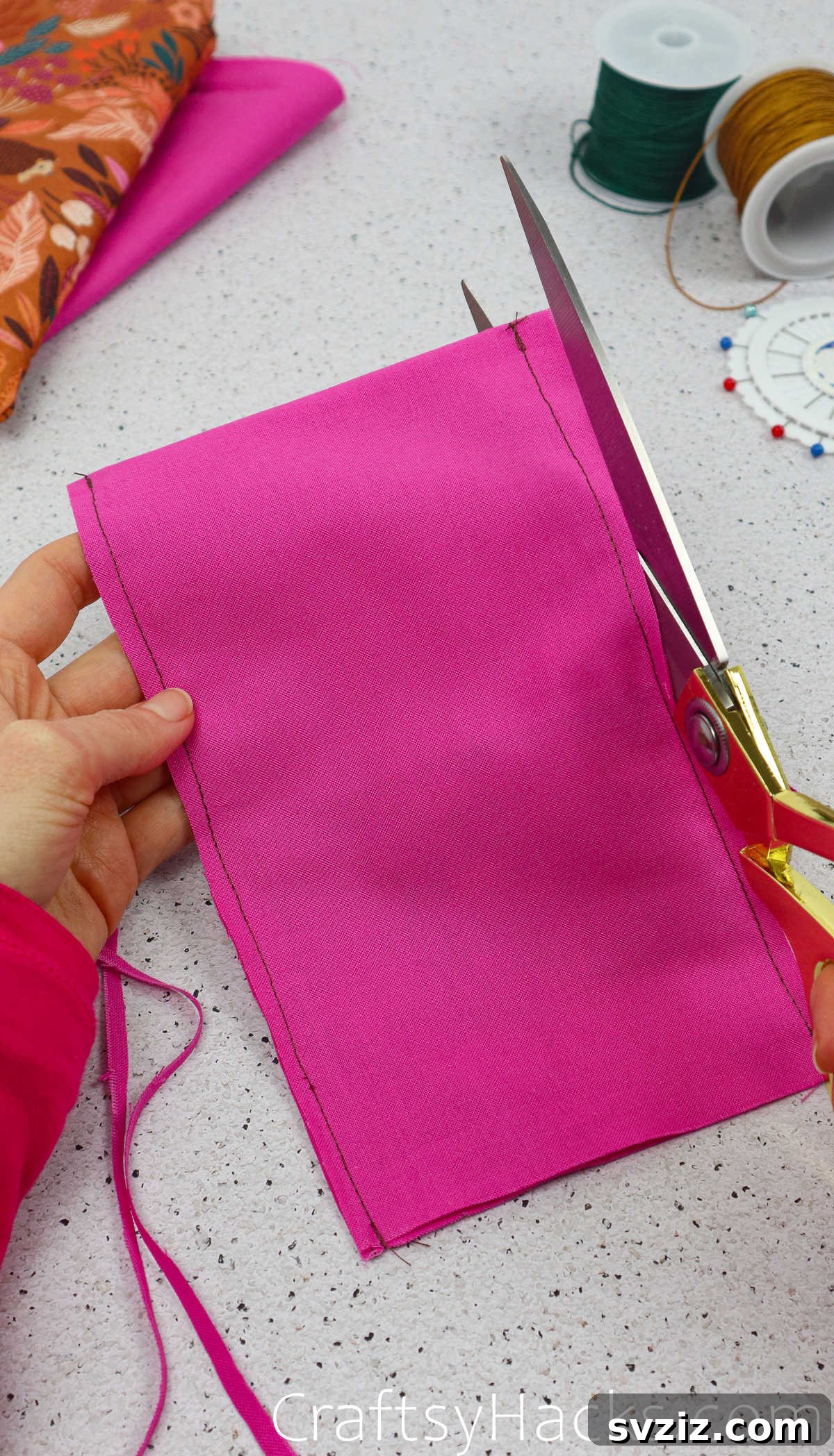 Scissors trimming excess fabric from the lining's seam allowances, ensuring a clean and less bulky finish.