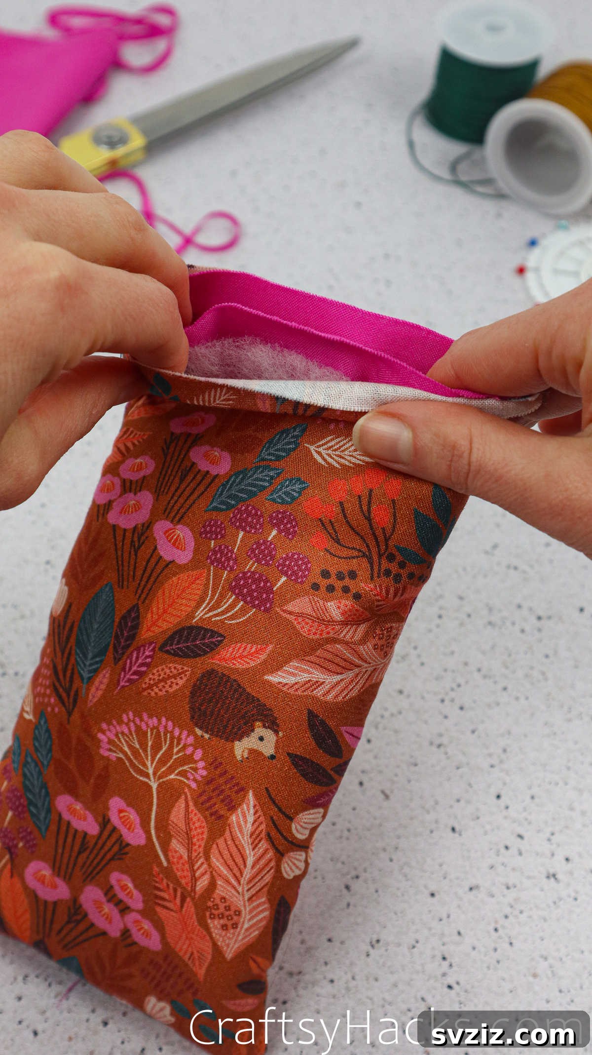 The outer fabric and inner lining carefully aligned at the top edge, ready to be pinned and sewn.
