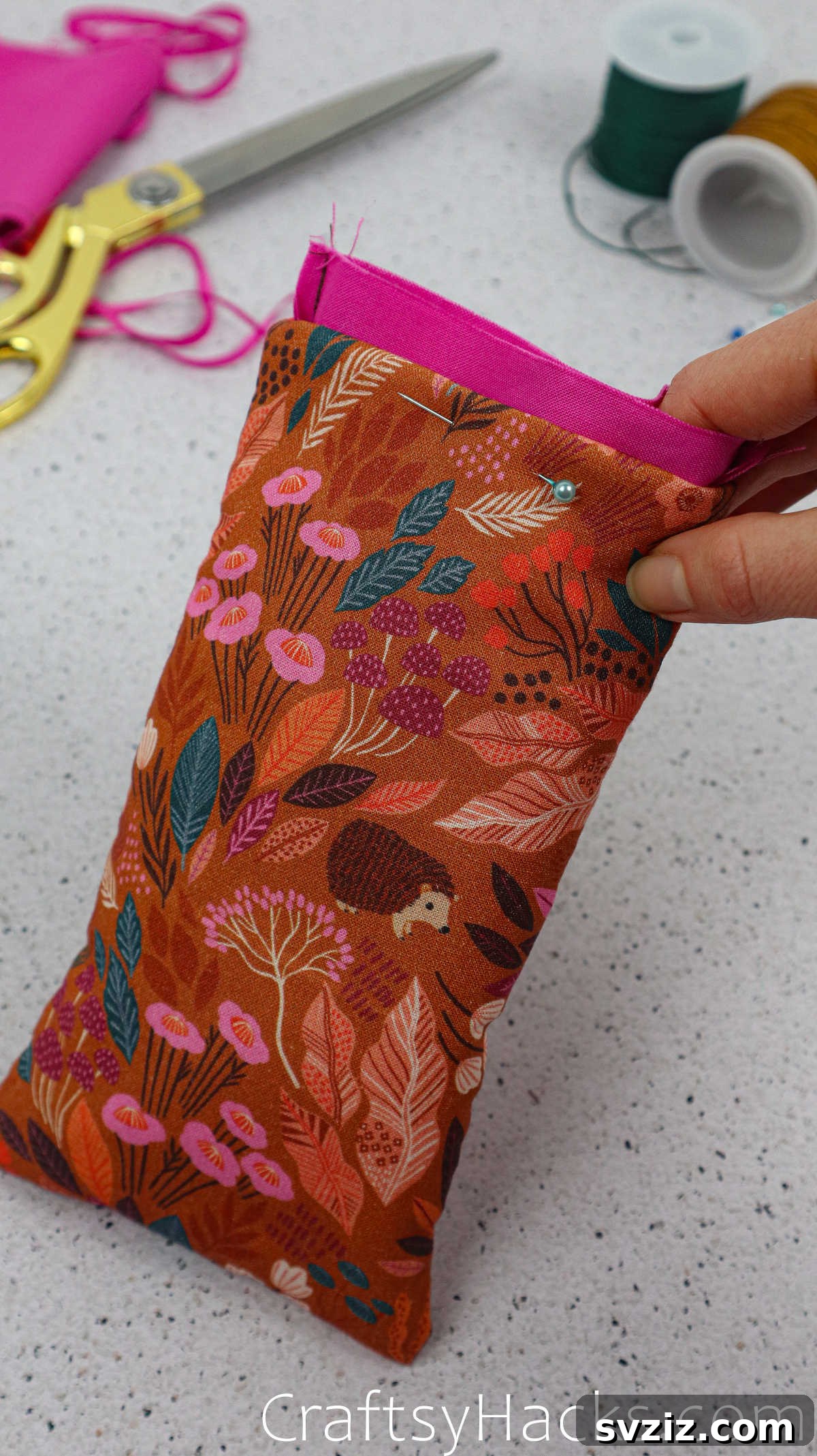 Pins holding the folded edges of the outer fabric and lining, ready for the final top stitch.