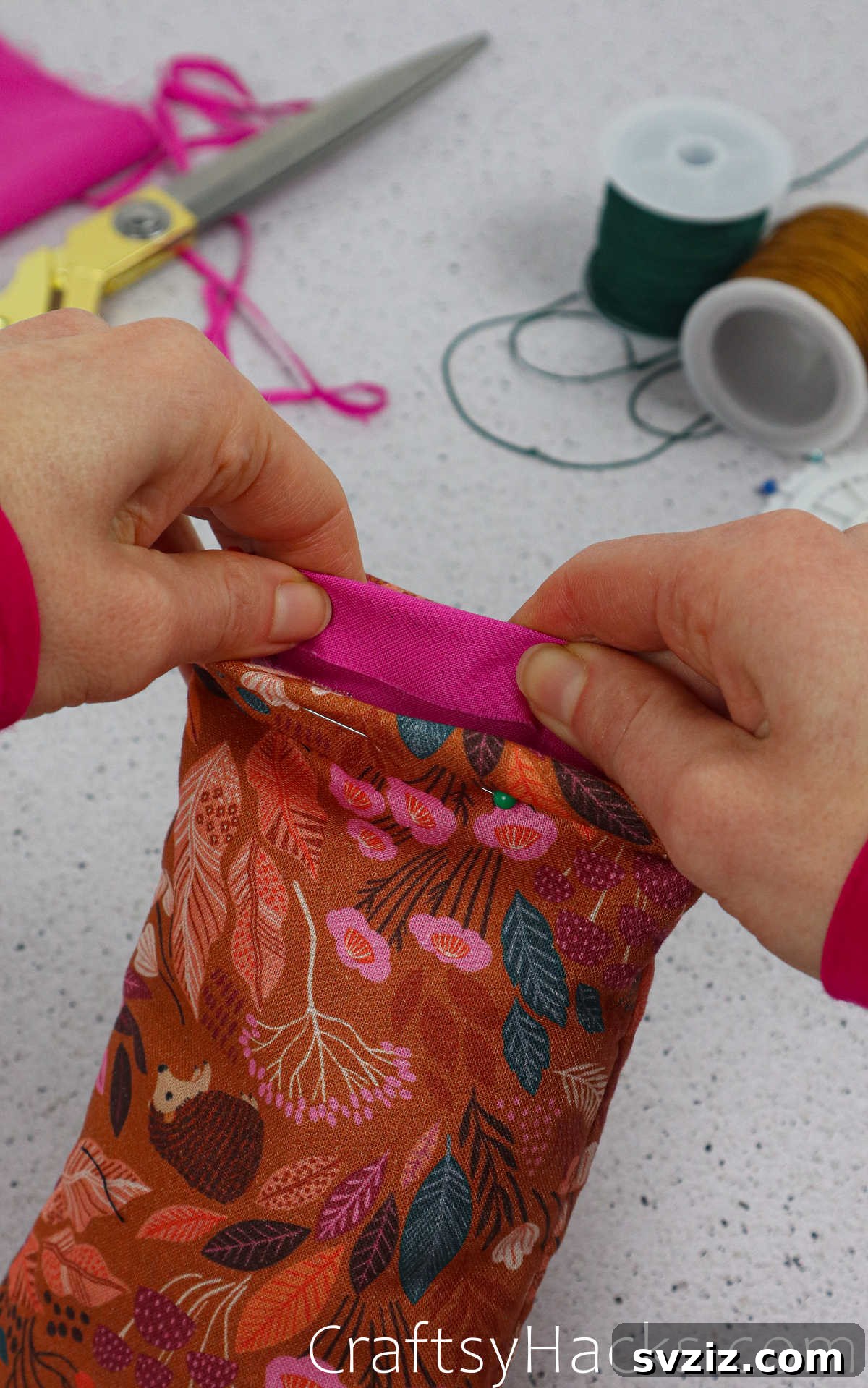 The top edge of the fabric case neatly folded inward, showcasing the clean finish before final stitching.