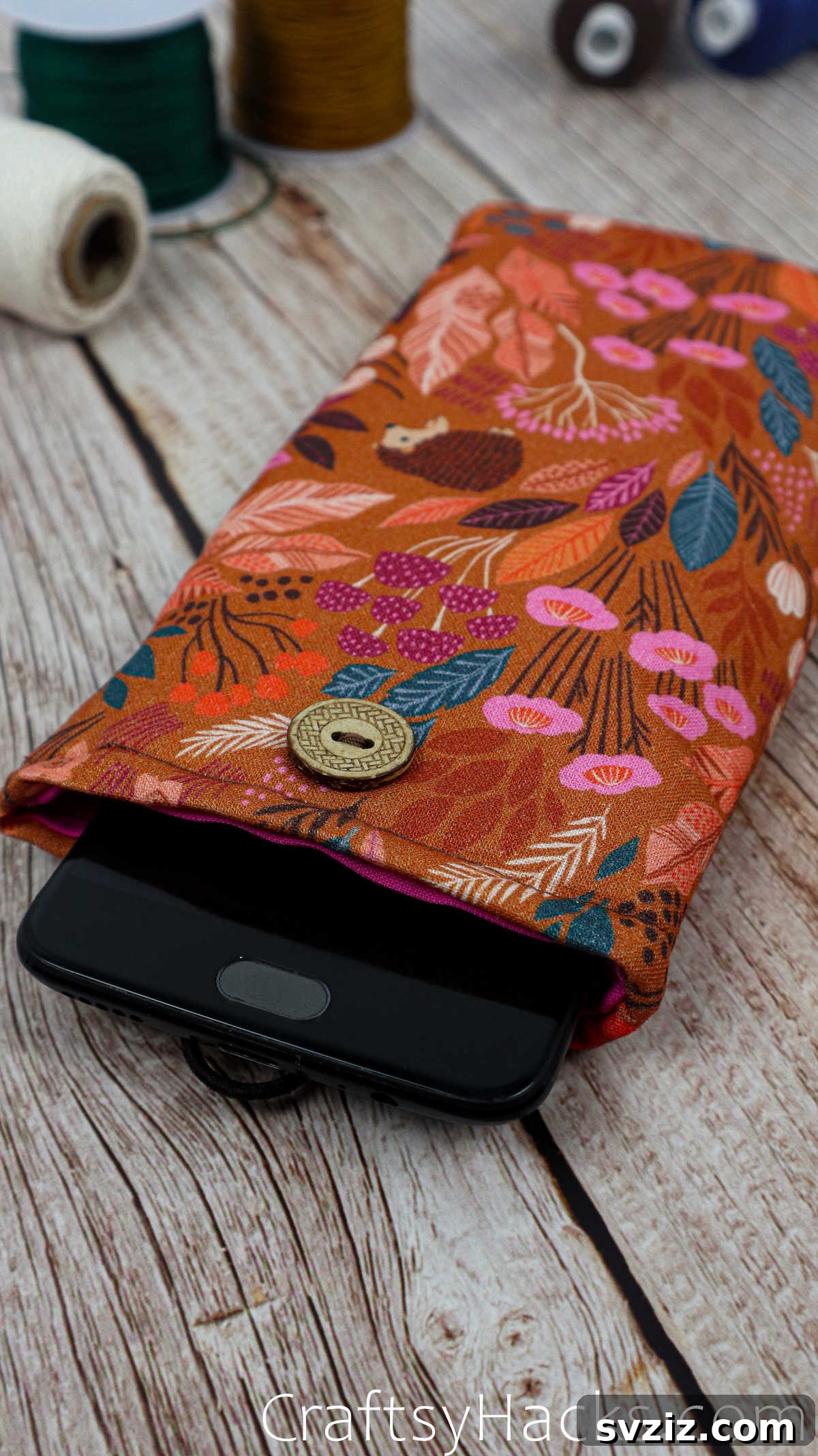 A smartphone snugly placed inside a handmade fabric phone case, illustrating the perfect fit and stylish protection.