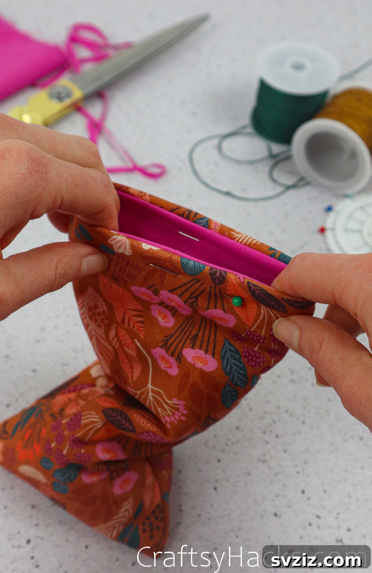 Pins securing all layers of the phone case at the top opening, ready for the final topstitch to enclose all raw edges.