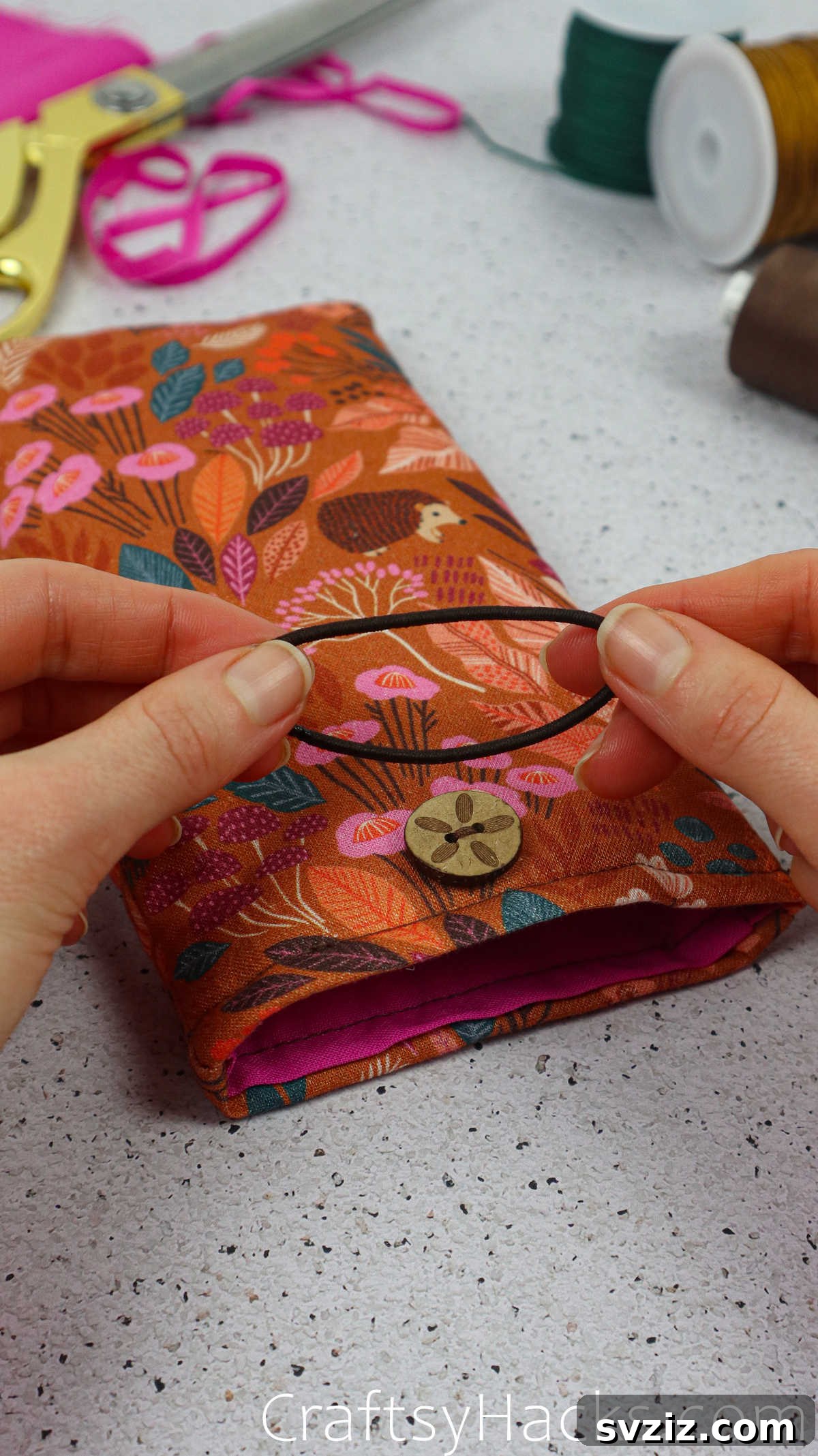 An elastic hair tie, chosen to create the loop closure for the fabric phone case.