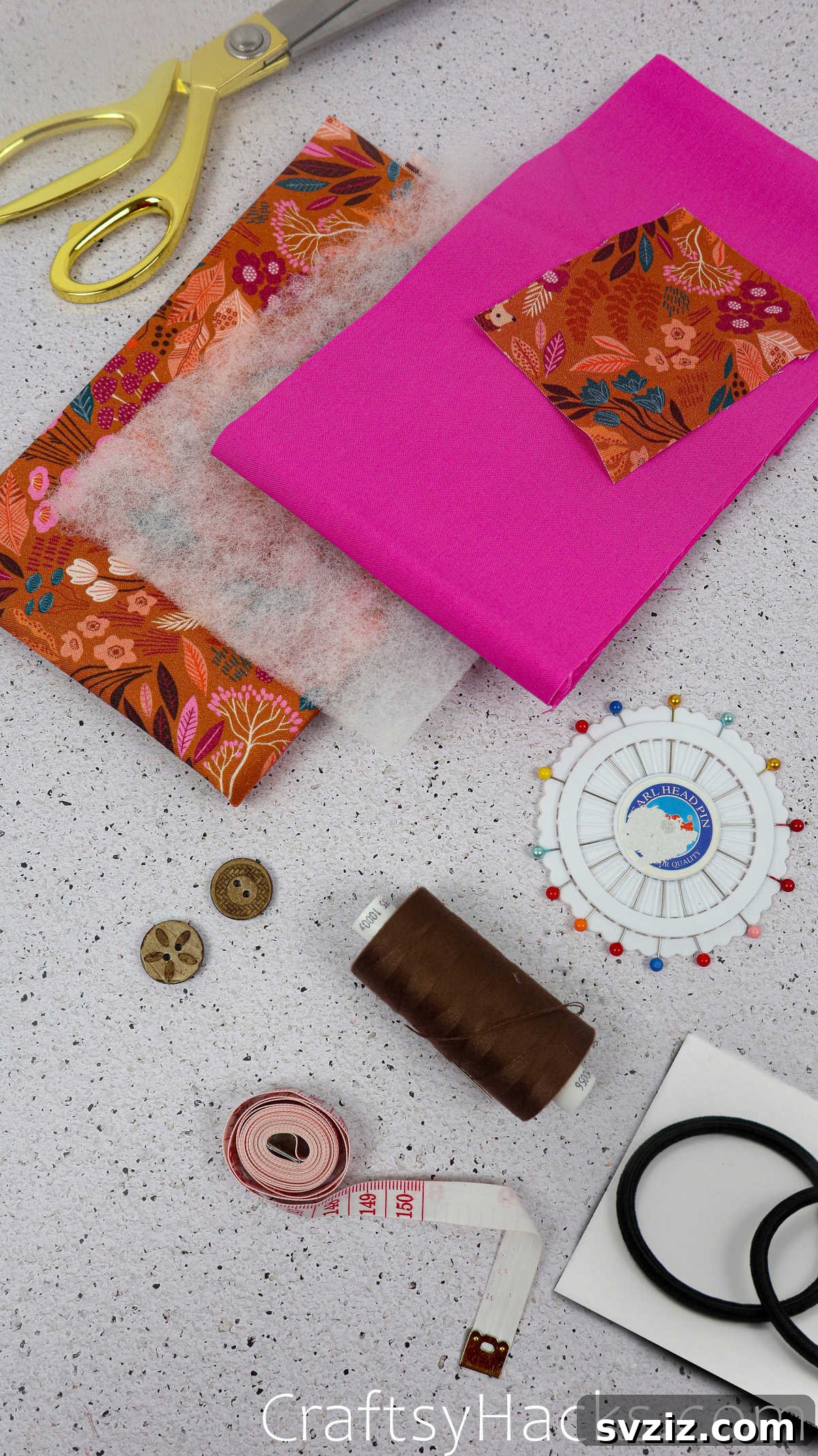 A collection of sewing supplies laid out for a DIY fabric phone case project, including fabric, scissors, and thread.