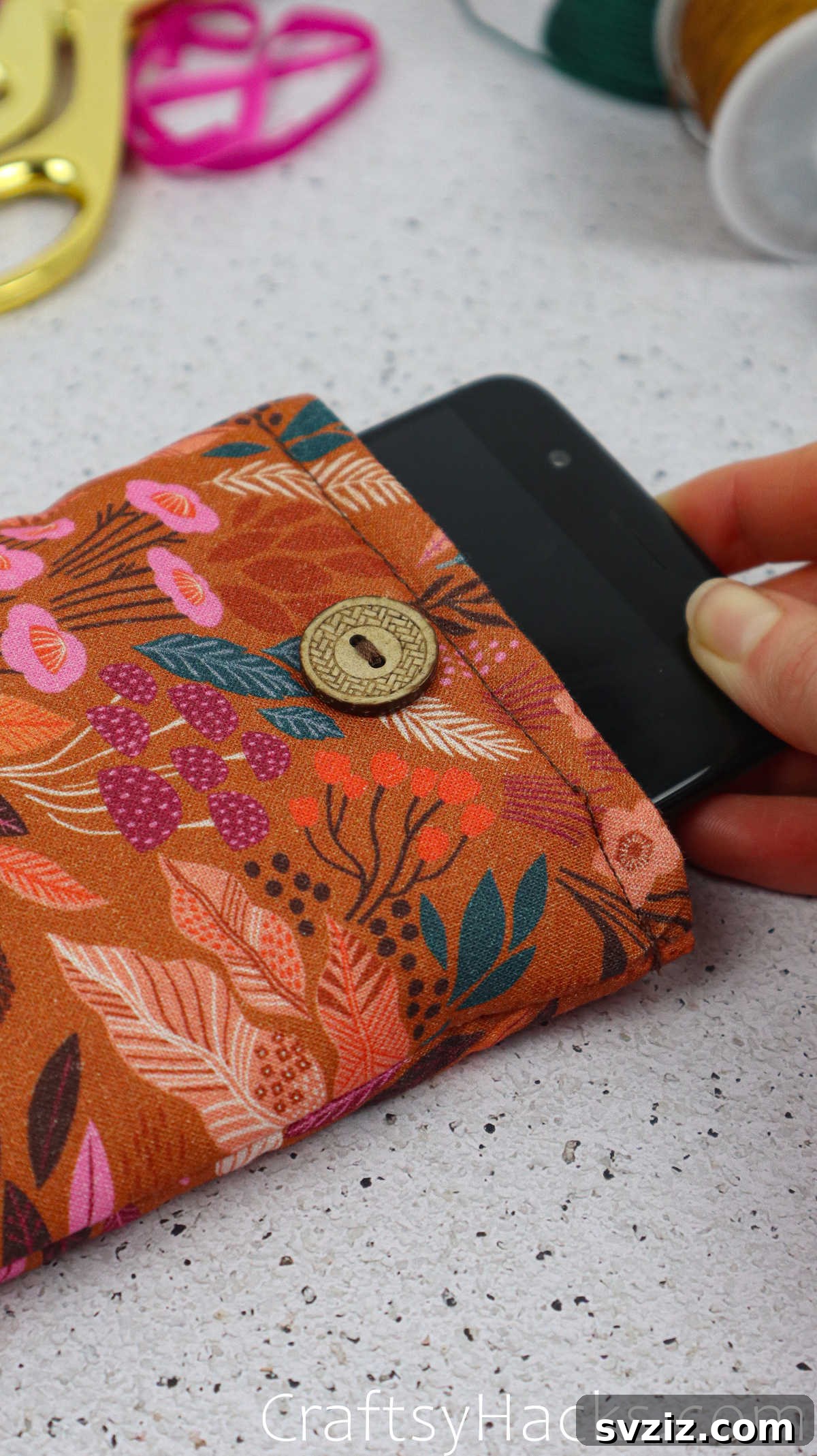 A smartphone comfortably resting inside its new fabric case, highlighting the snug fit and protection it offers.
