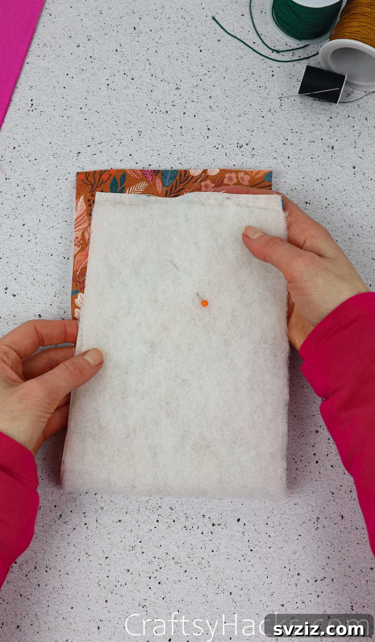 The main fabric and wadding neatly folded in half, demonstrating the foundation of the phone case structure.