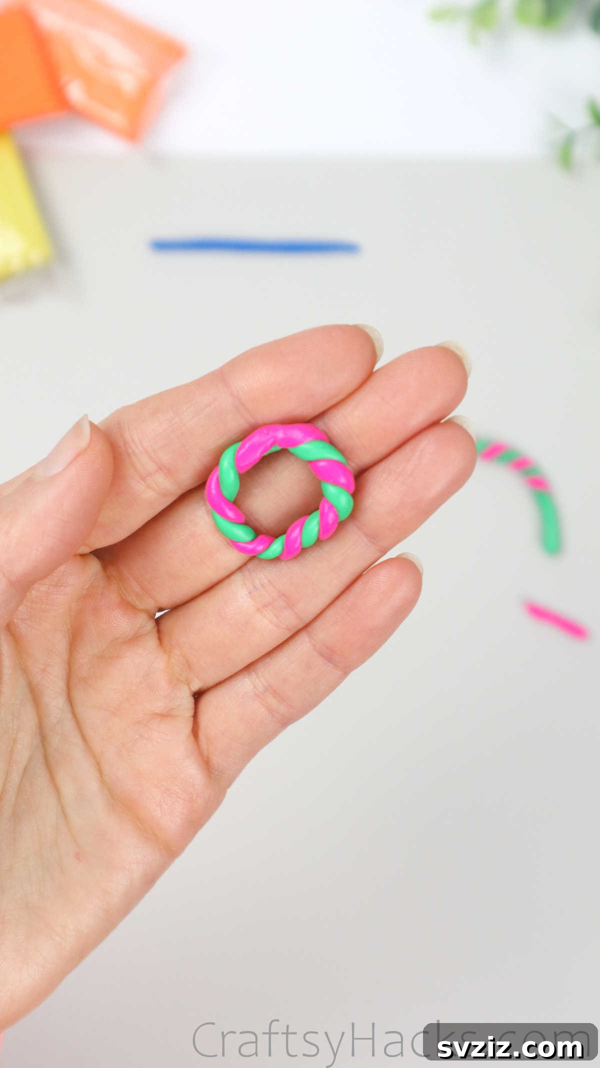 Crafting Your Own Clay Rings Effortlessly 20 A finished pink and green twisted polymer clay ring, showcasing its delightful candy cane design