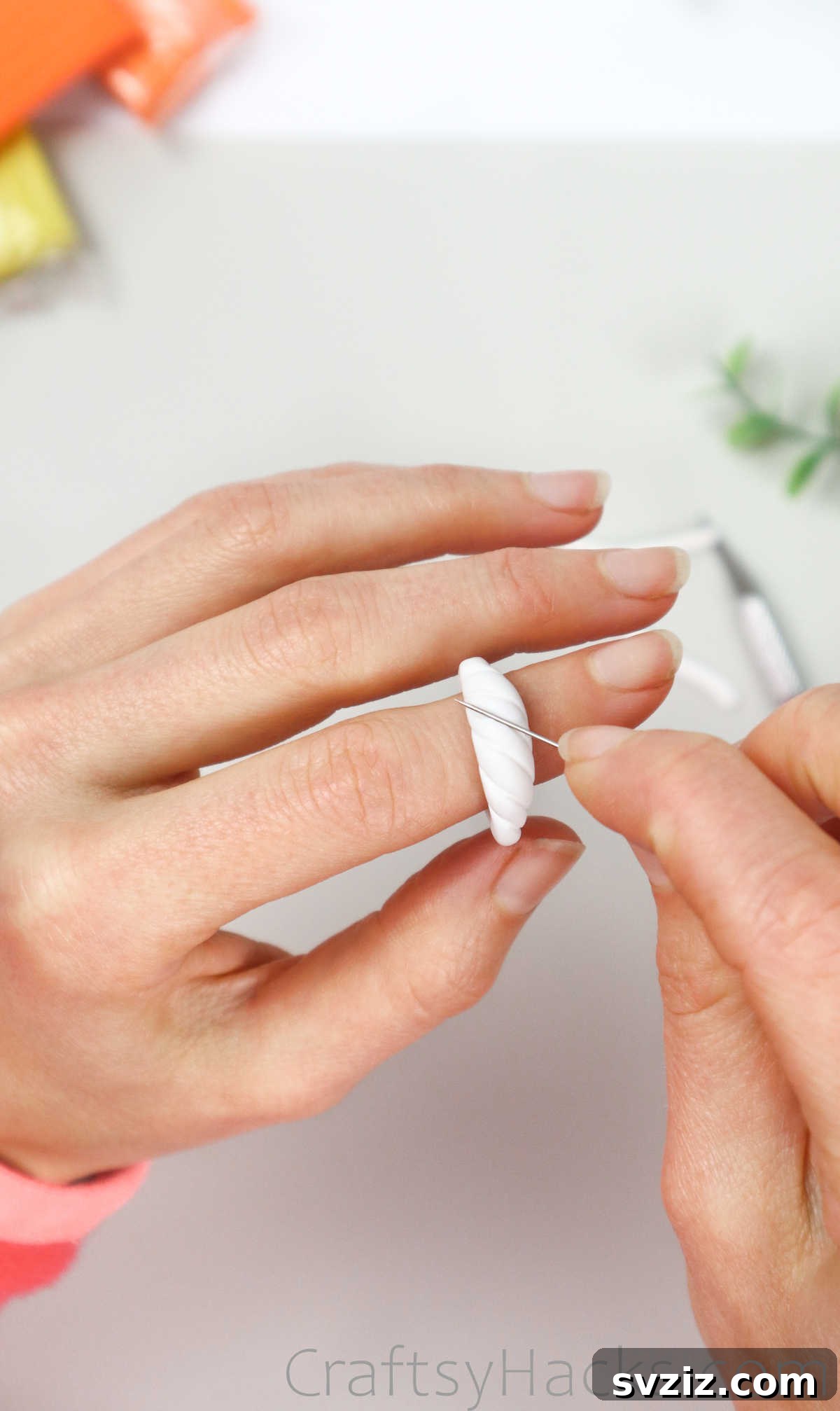 Crafting Your Own Clay Rings Effortlessly 24 A sewing pin creating delicate lines and textures on the raised bump of the white polymer clay ring