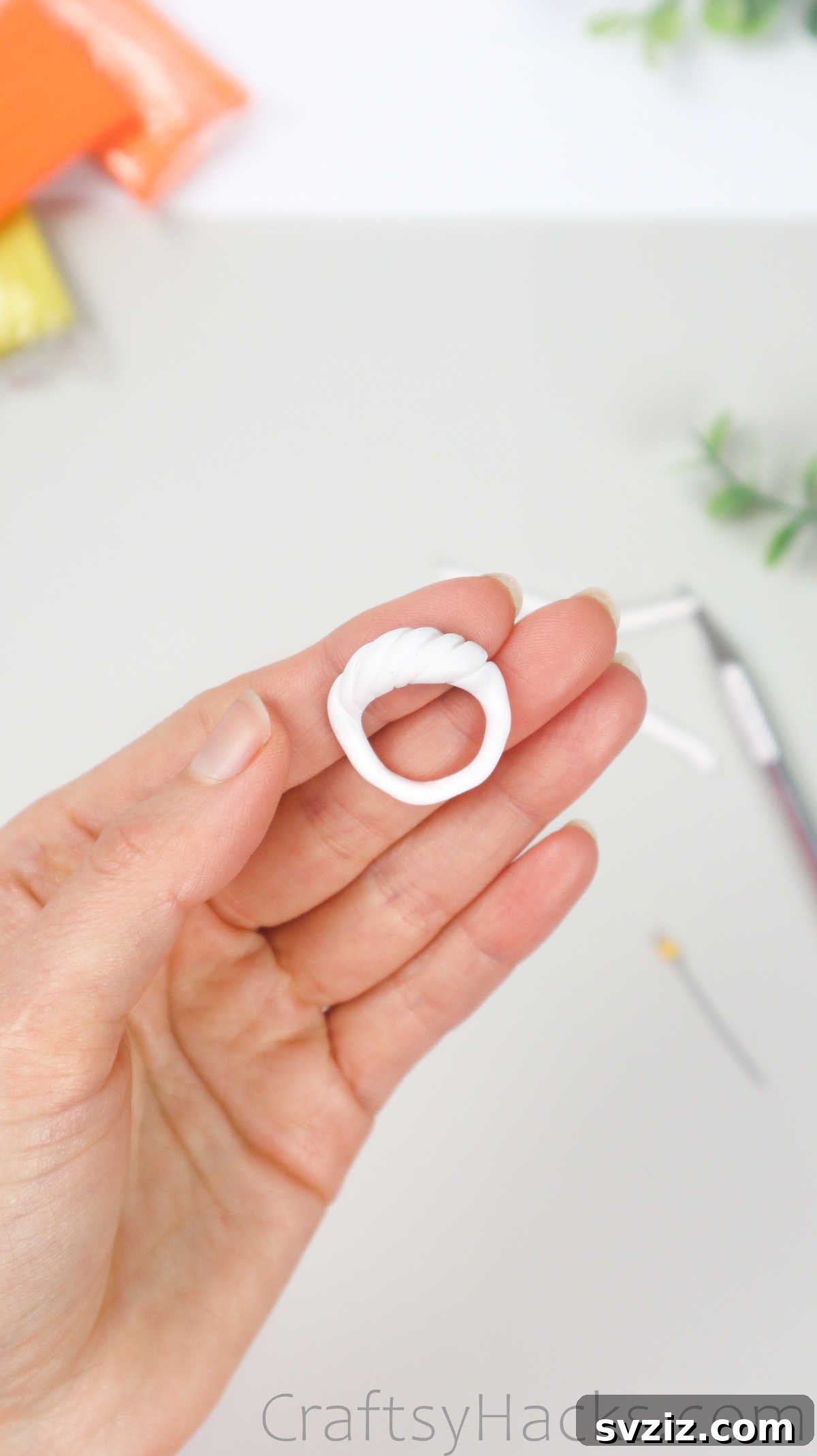 Crafting Your Own Clay Rings Effortlessly 25 A hand presenting the textured white polymer clay ring, showing the detailed grooves on its surface