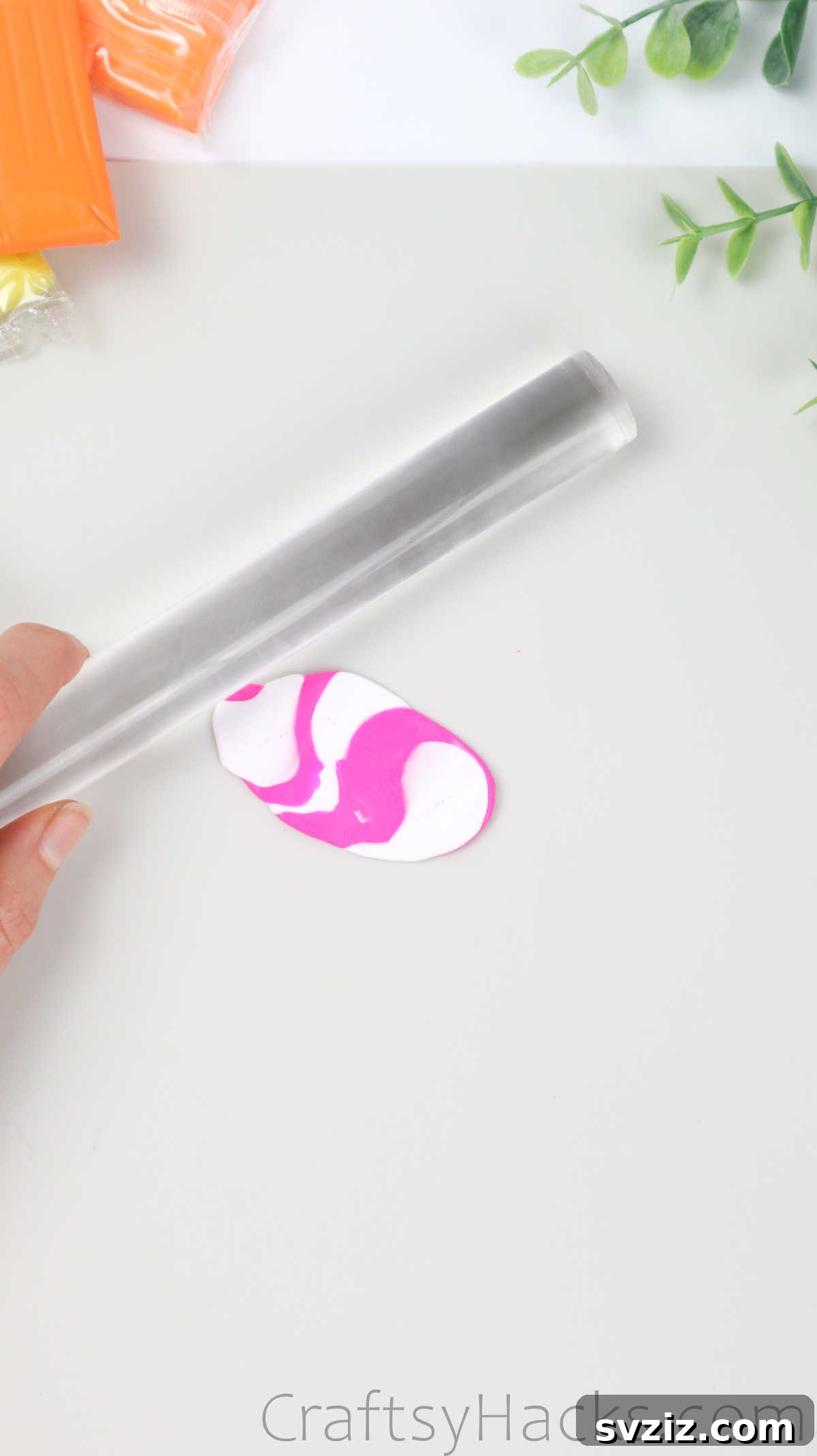 Crafting Your Own Clay Rings Effortlessly 28 A rolling pin flattening marbled polymer clay on a cutting mat to an even thickness