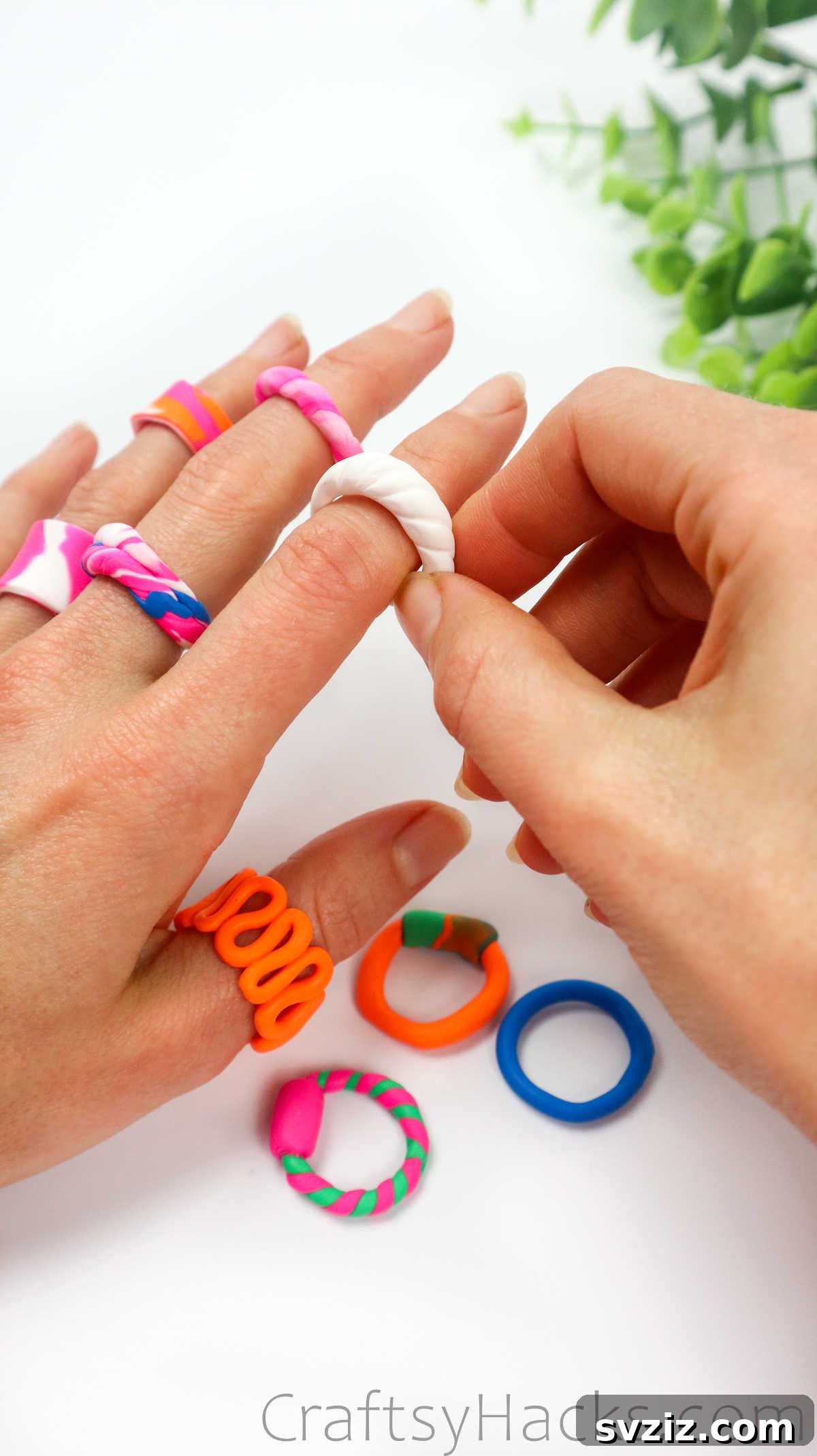 Crafting Your Own Clay Rings Effortlessly 35 A hand wearing several colorful and stylish polymer clay rings, showcasing the finished product