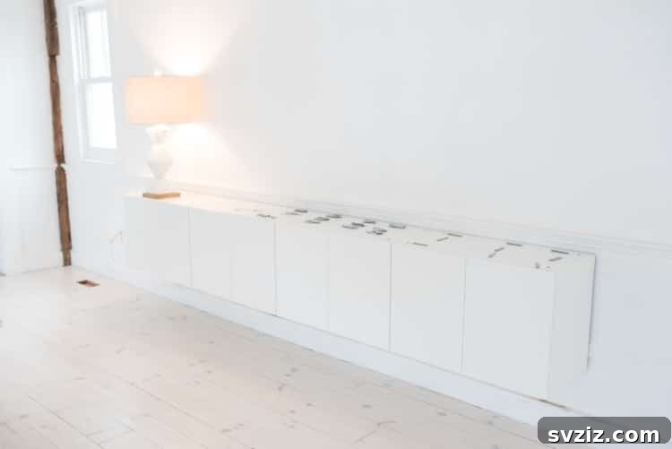 20 Game-Changing IKEA Kitchen Hacks 14 DIY credenza built from IKEA upper wall cabinets, creating stylish living room storage