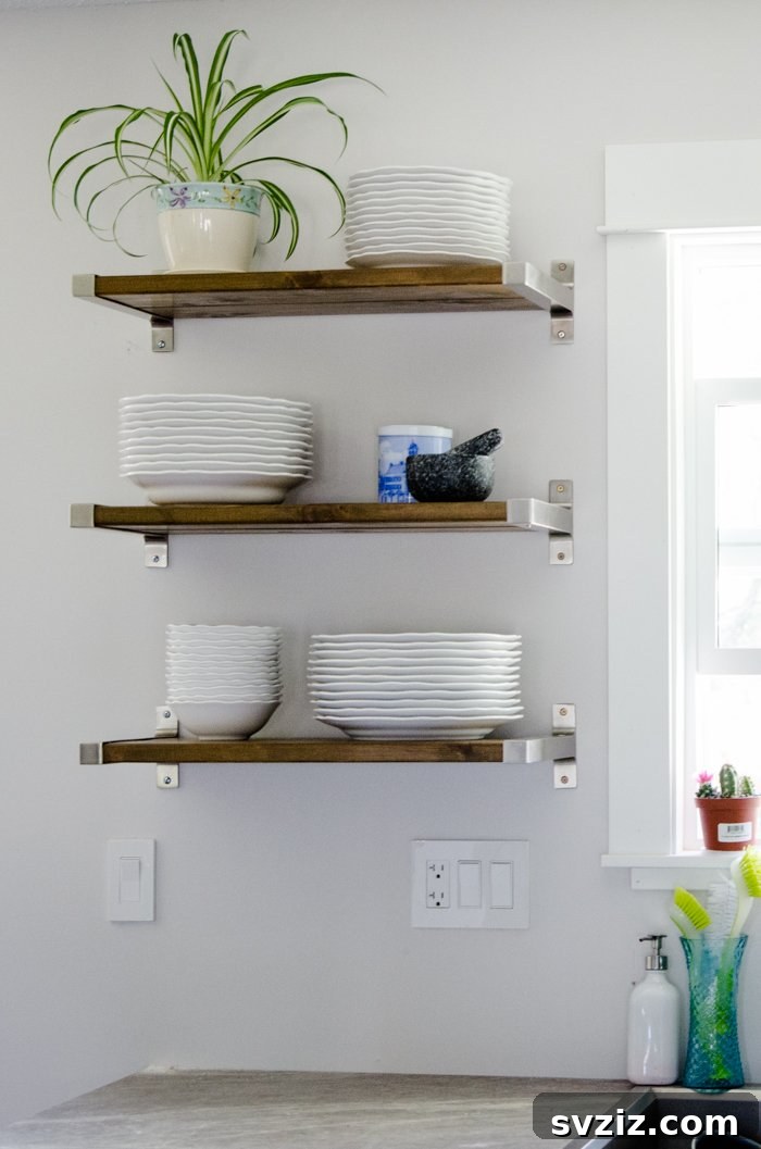 20 Game-Changing IKEA Kitchen Hacks 20 Industrial wall shelves in a kitchen created with IKEA stainless steel brackets and wooden planks