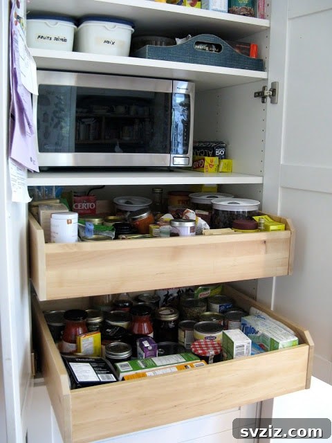 20 Game-Changing IKEA Kitchen Hacks 10 Customized kitchen pantry with sliding wooden drawers from IKEA PAX Wardrobe