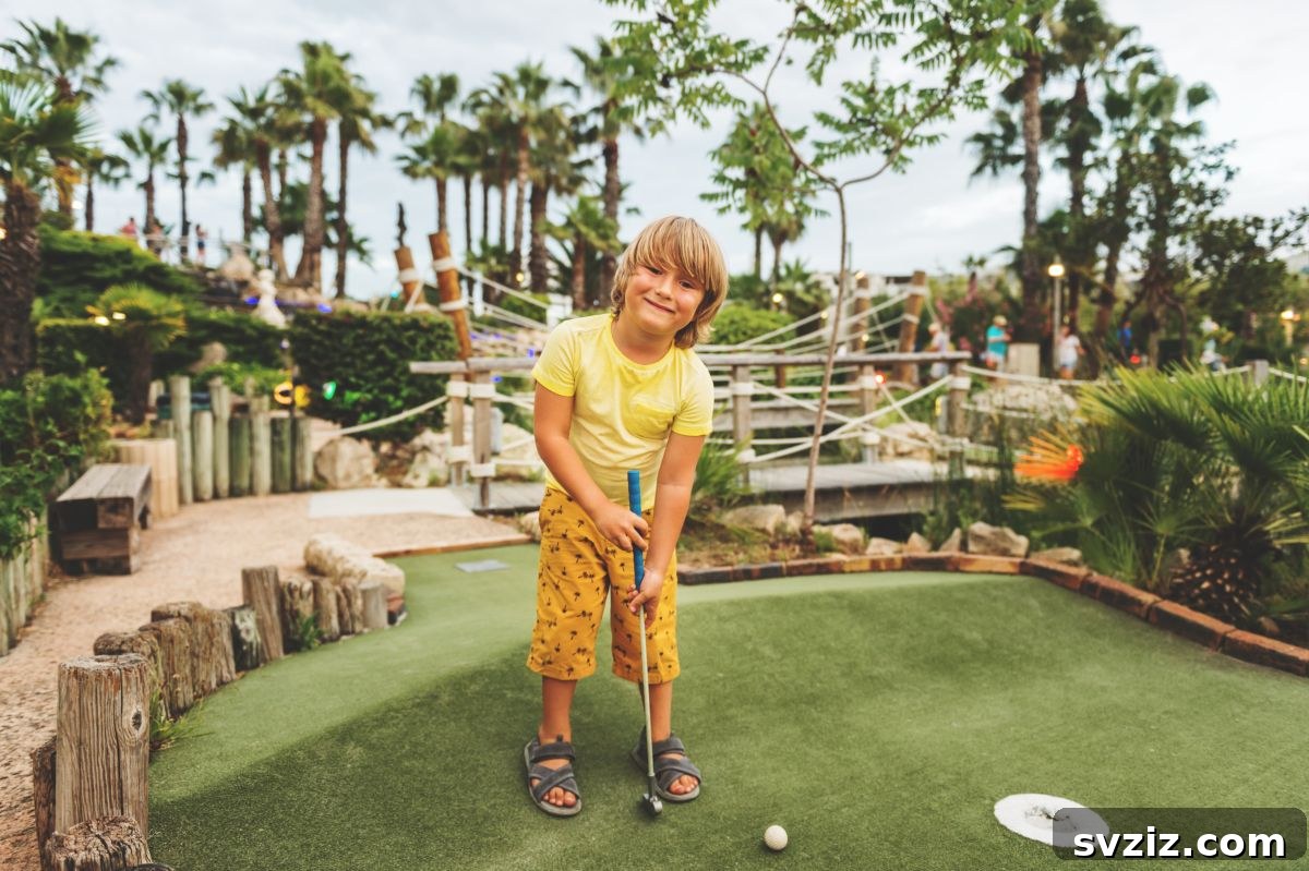 Kids putting on a mini-golf course outdoors