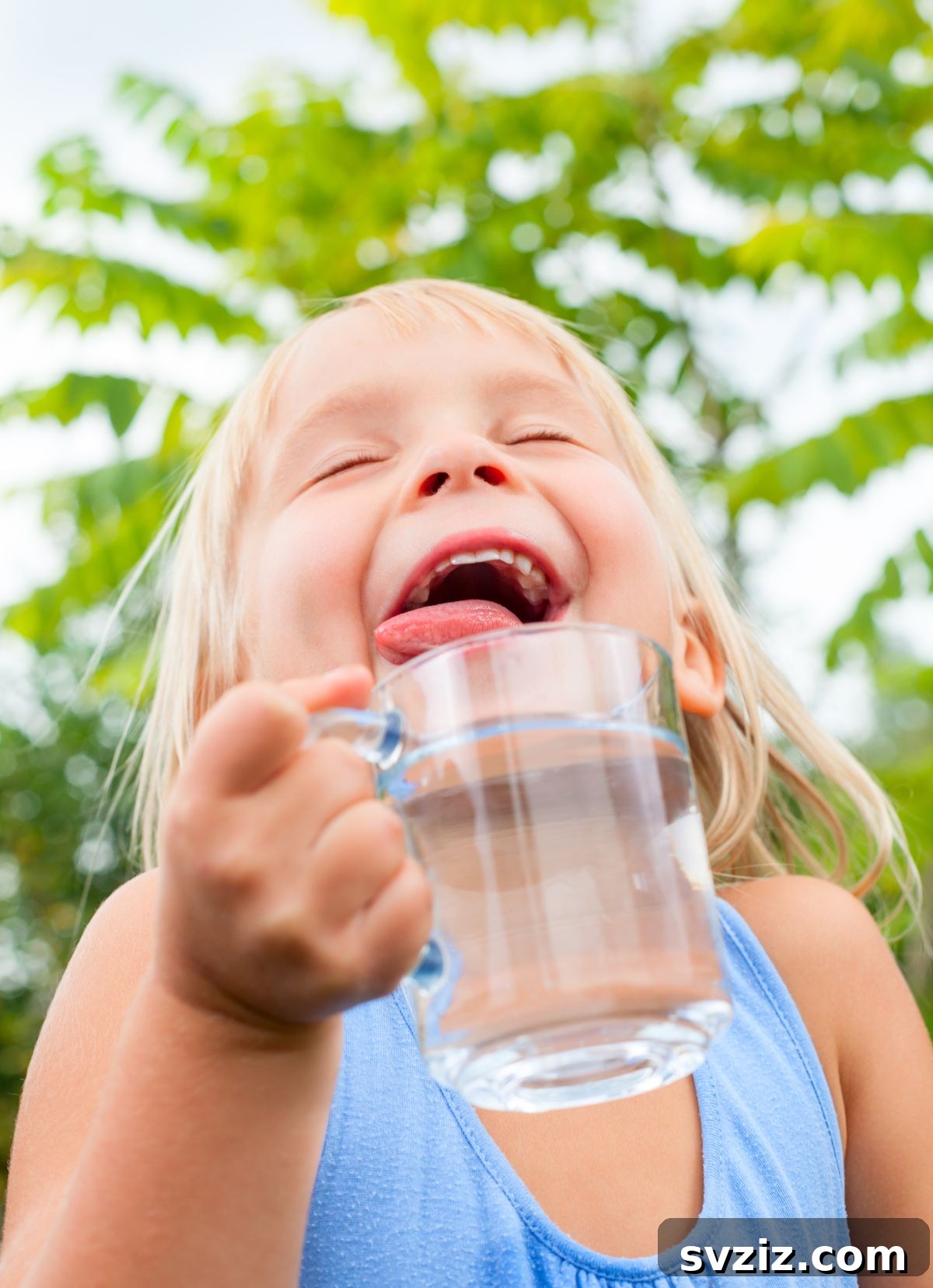Children carefully passing water down a line with cups