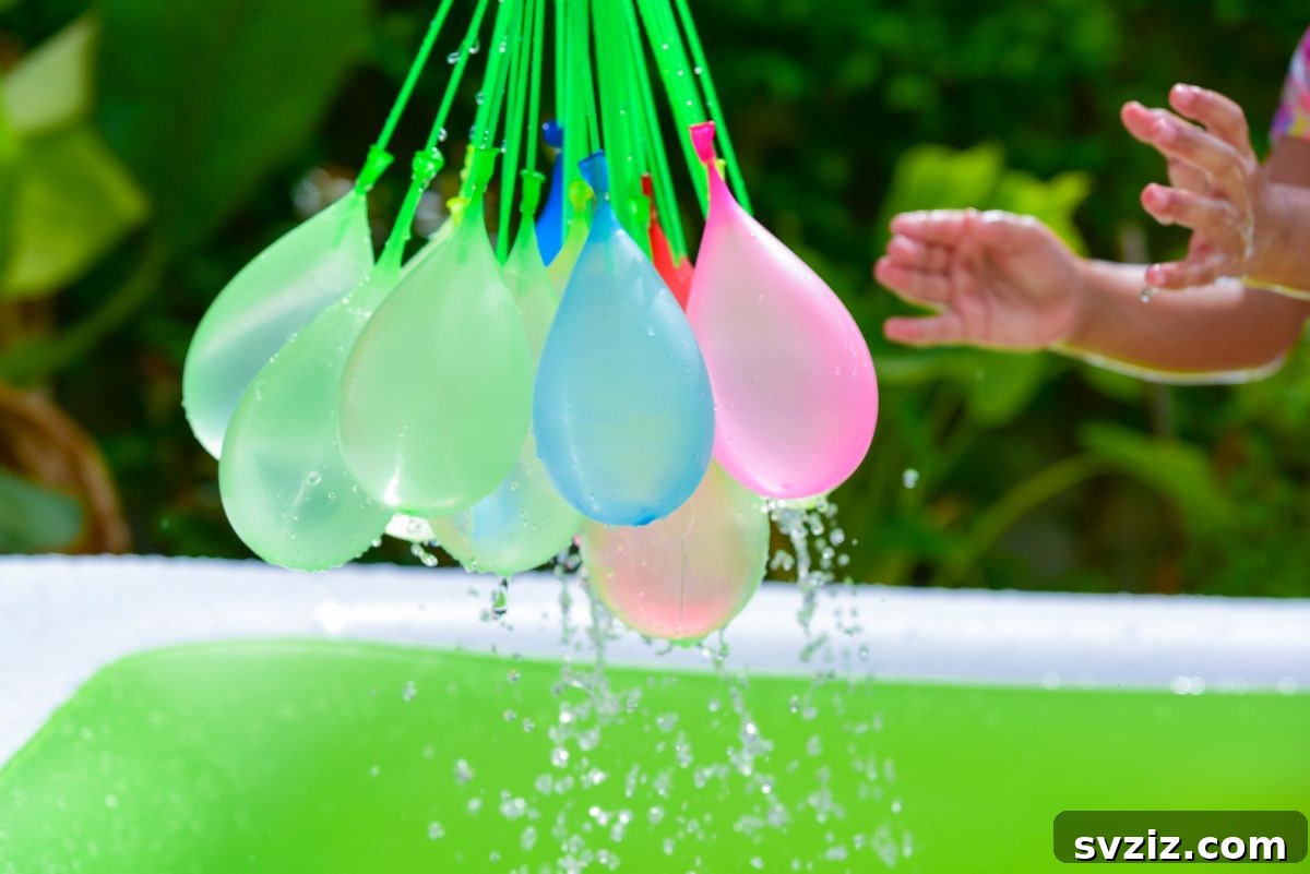 Kids gathered around a bursting water balloon pinata
