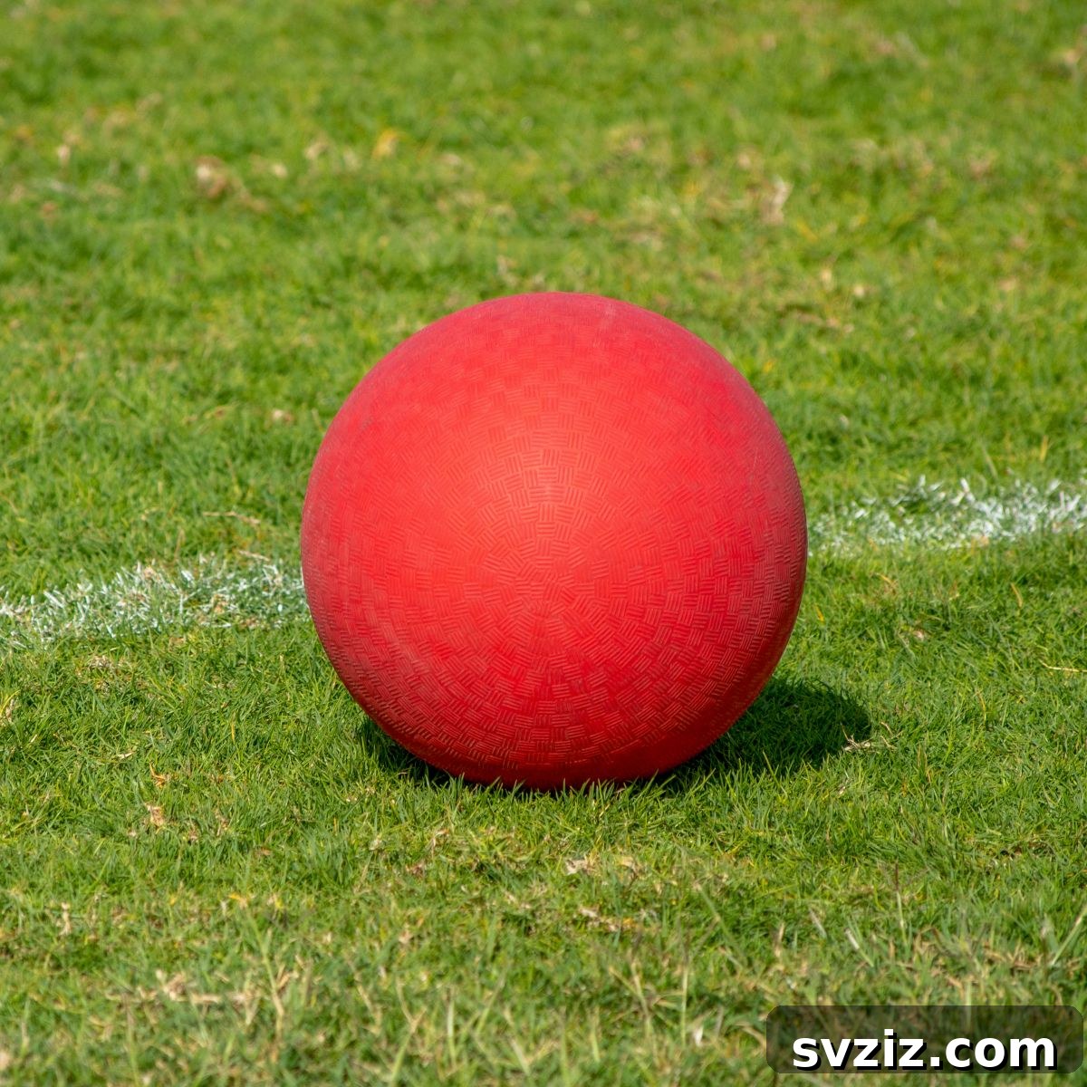Kids enthusiastically playing dodgeball with soft balls outdoors