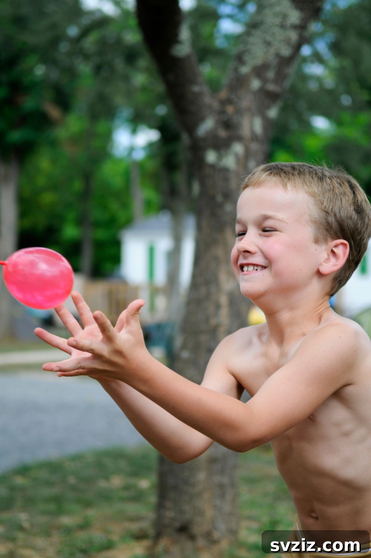 Kids carefully tossing a water balloon outdoors